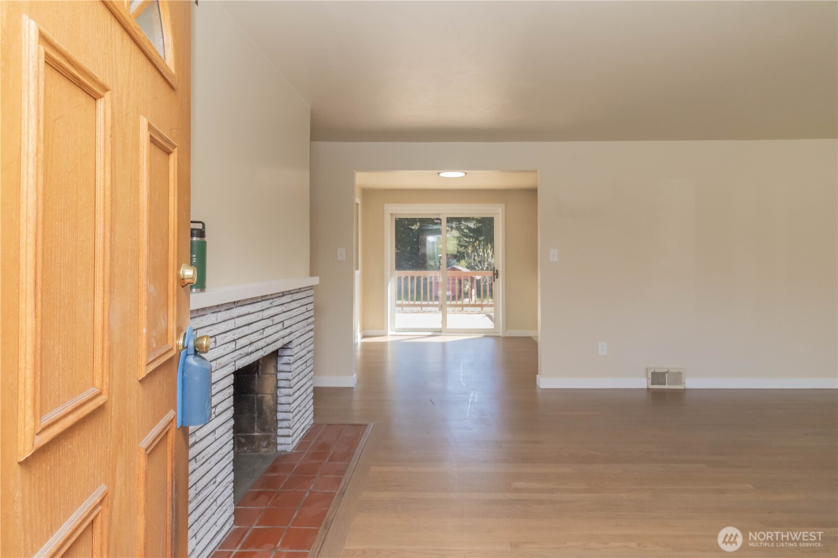 Upstairs entry to formal living room, with warm wood burning fireplace