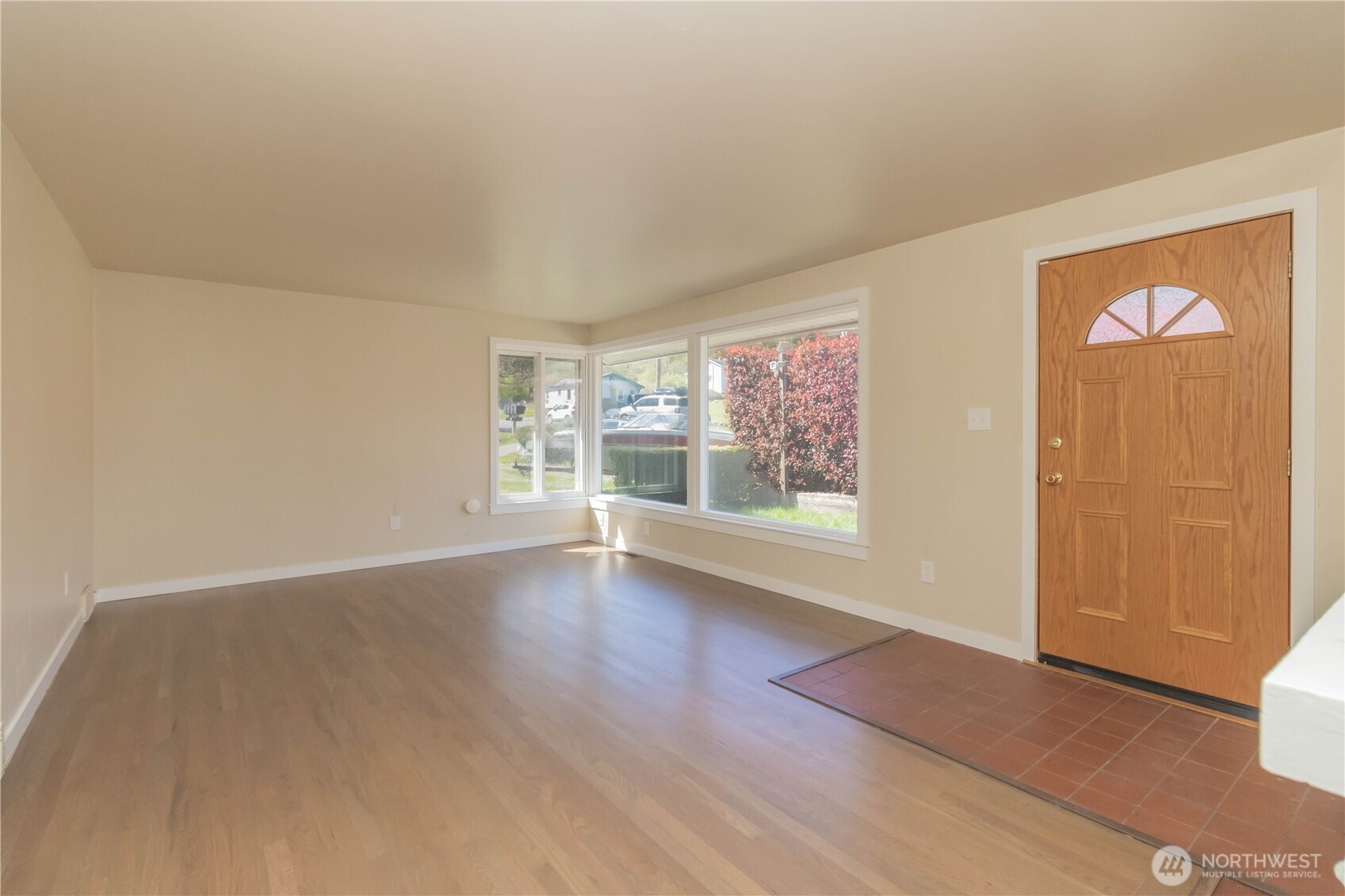 Another view of large picture windows in formal living room