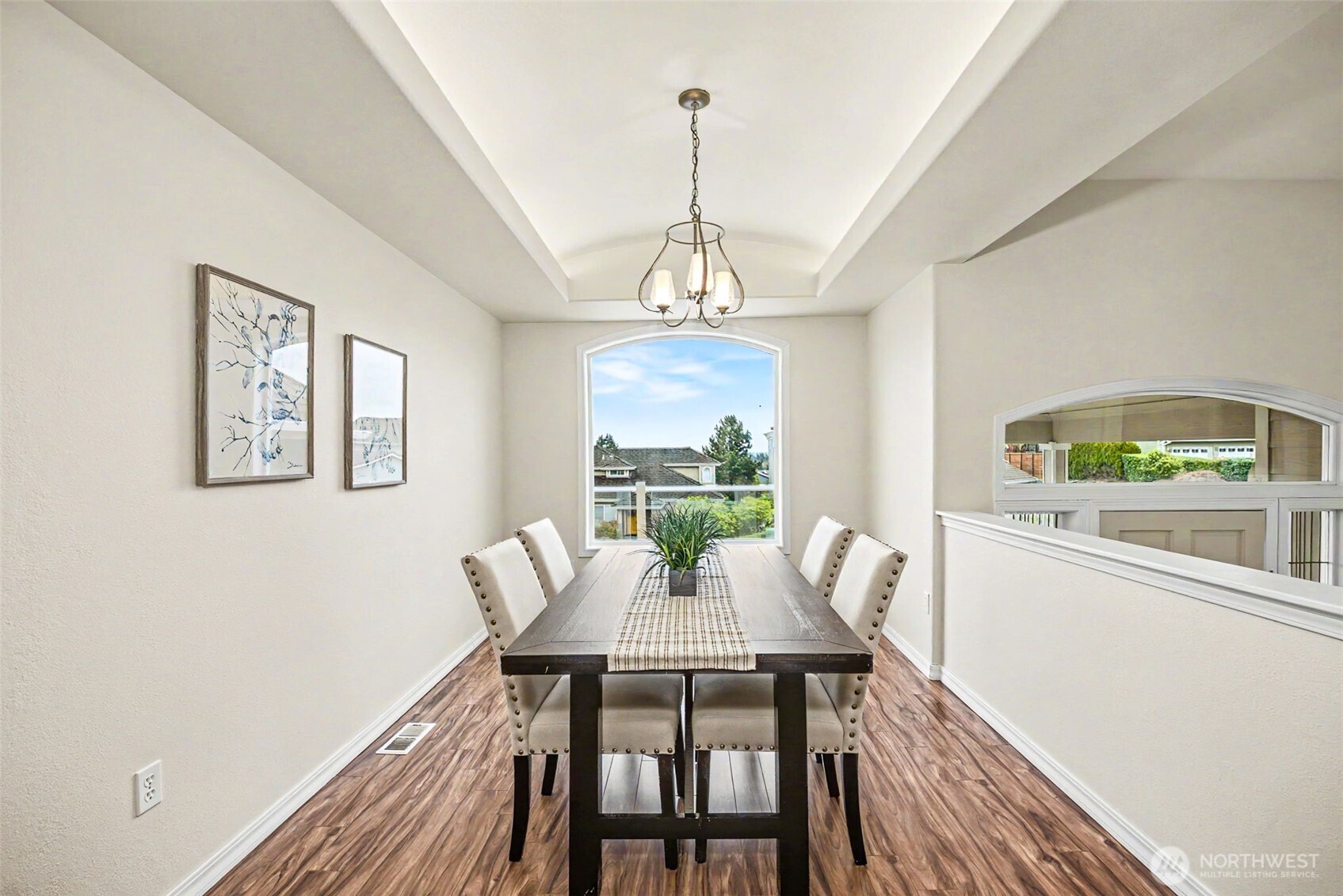 Dining area with natural light and backlit coved ceilings.