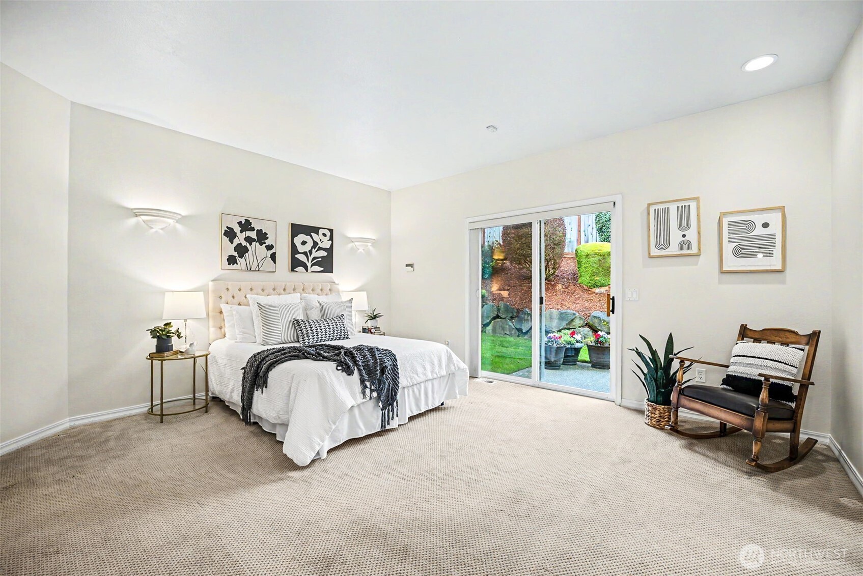 Primary bedroom with private spa-like bathroom and two walk-in closets.