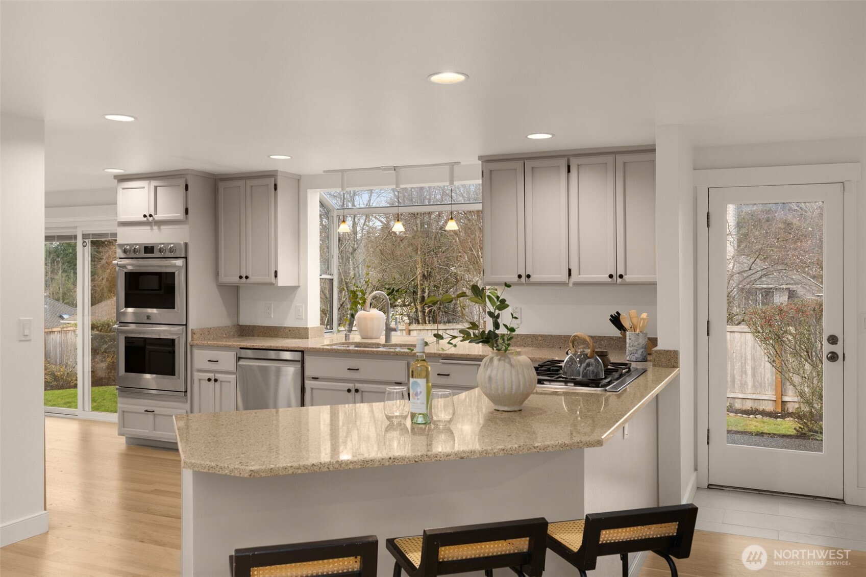 Updated kitchen features sleek cabinetry, quartz counters, and premium stainless appliances,