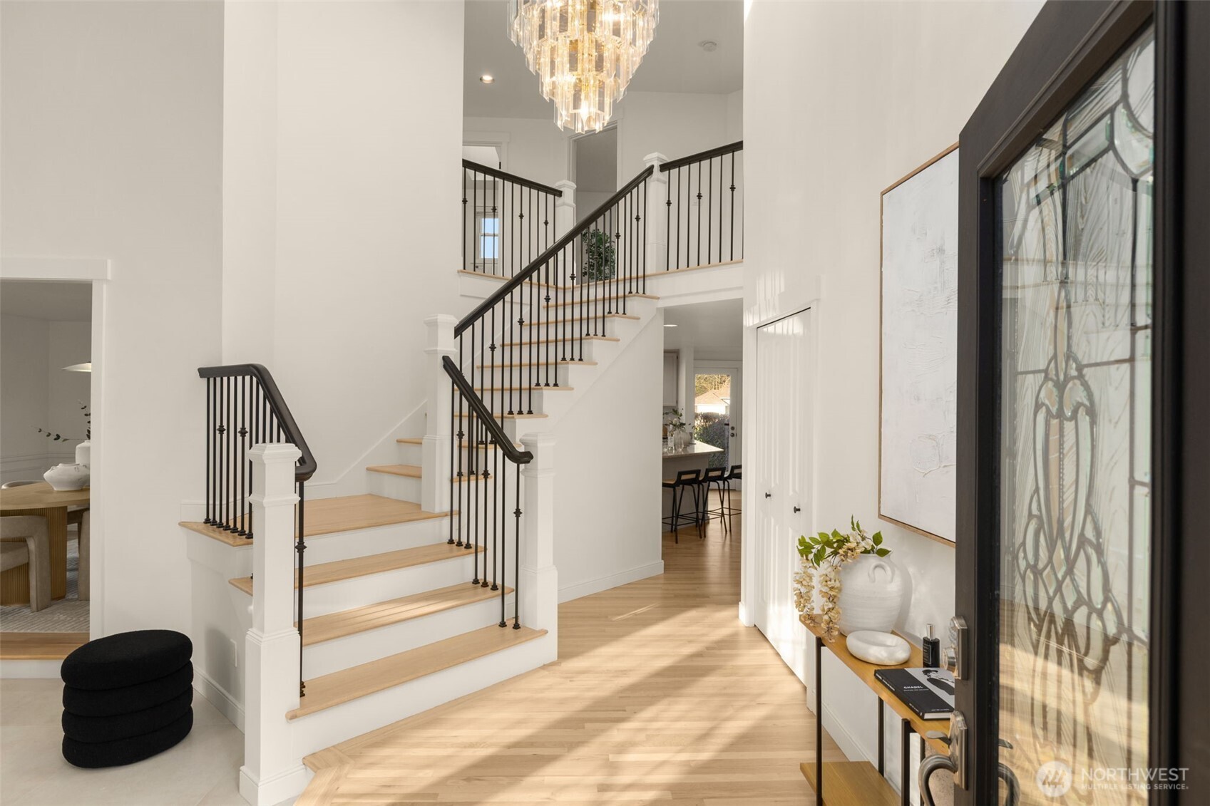 Welcome inside to cathedral ceilings and custom wrought iron rail staircase.