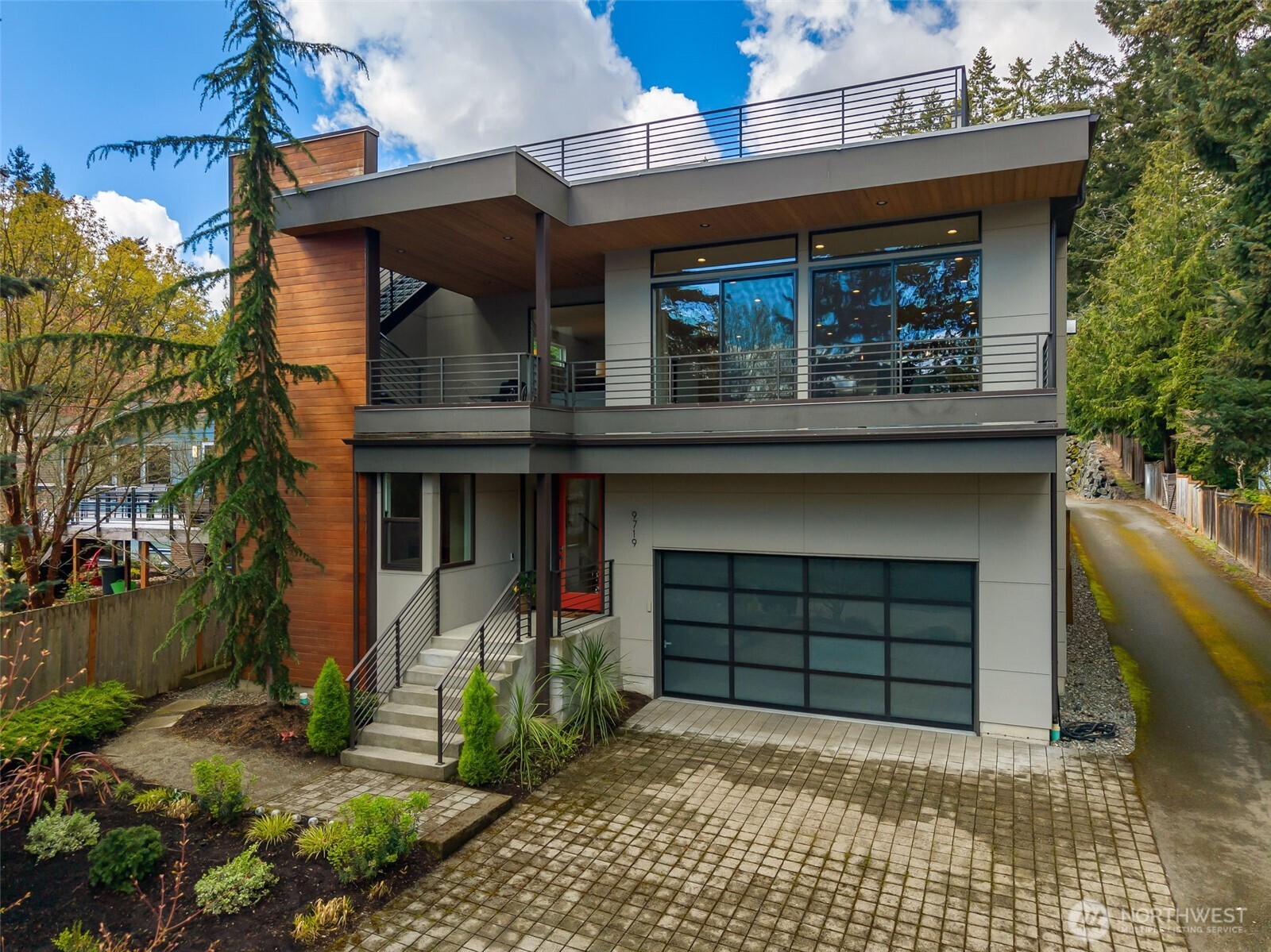 An oversized attached garage with plenty of driveway parking. Plus, a dedicated off-street spot in front (out of frame).