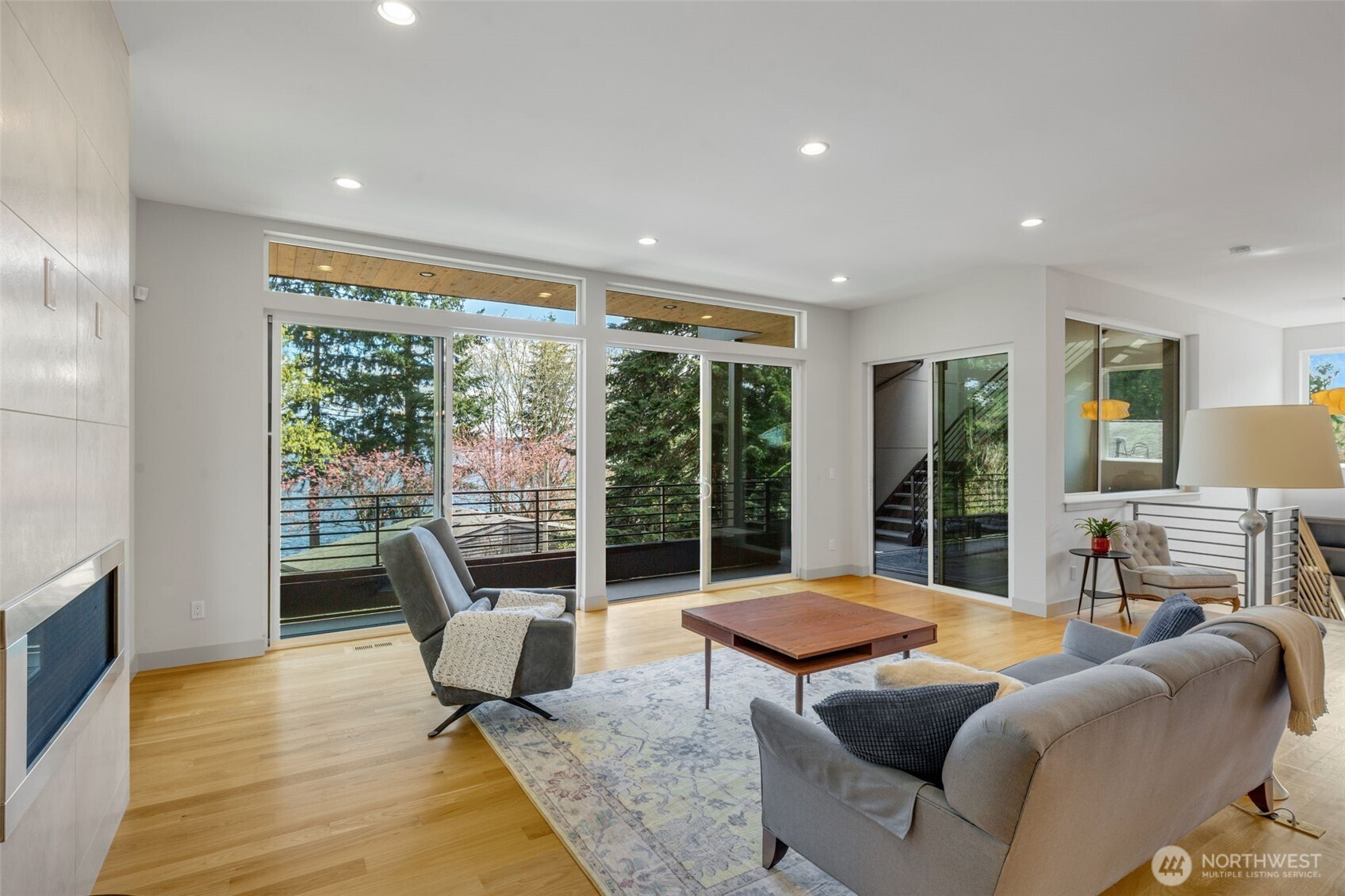 Walls of glass open to a covered balcony, which leads to the roof deck.