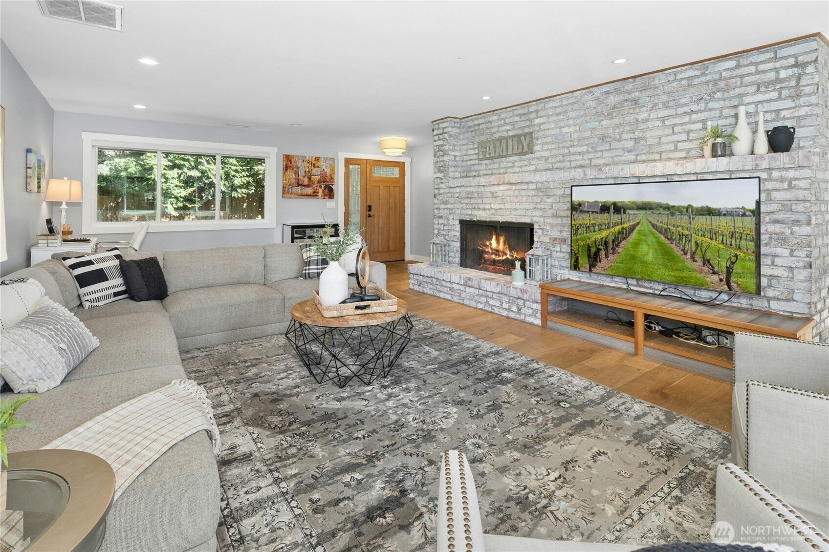 Living room with fireplace and brick accent wall