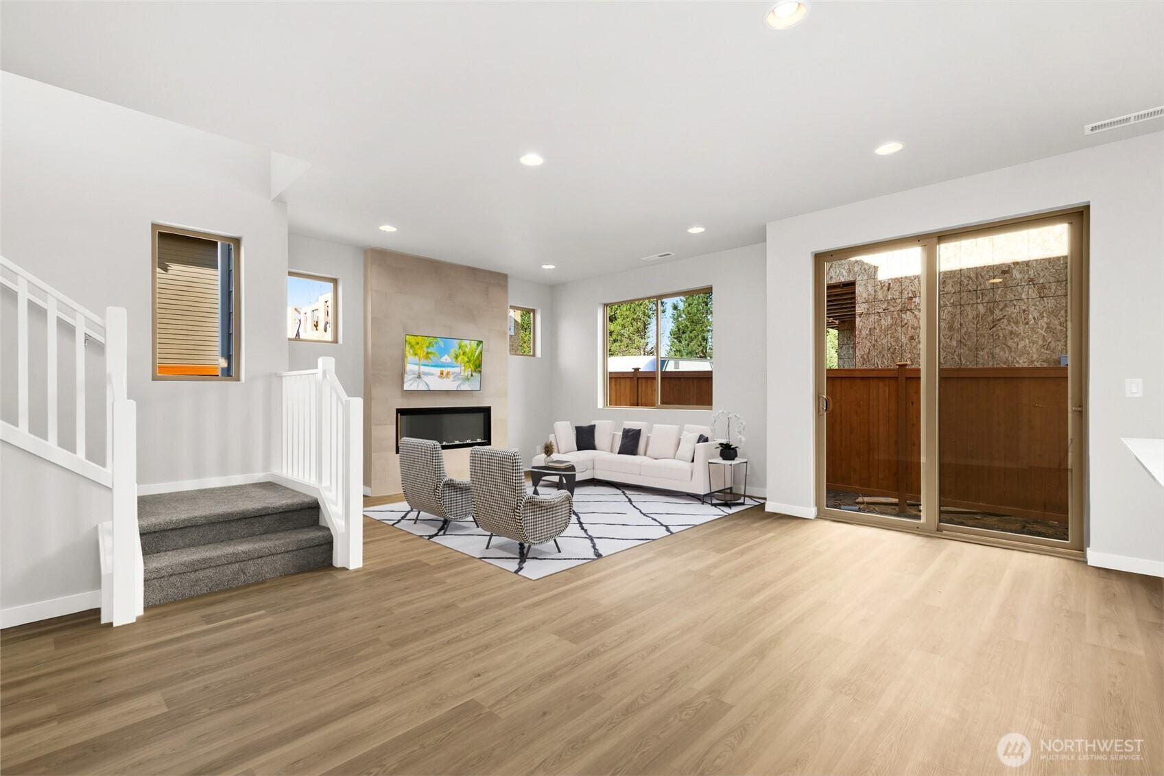 Open Living and Dining room that leads to the patio through large sliders for indoor/outdoor living. Virtually staged.