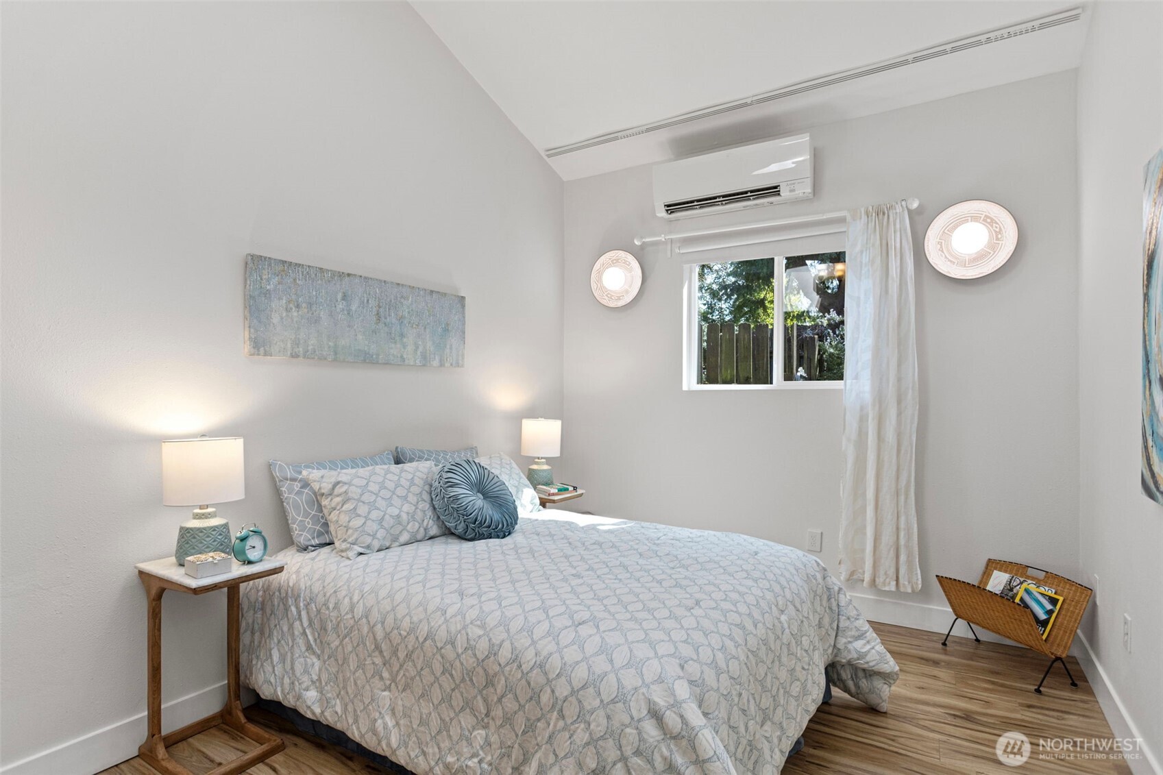 The second bedroom — vaulted ceiling, mini-split, wall sconces, south-facing window. Not what you'd expect at this level.