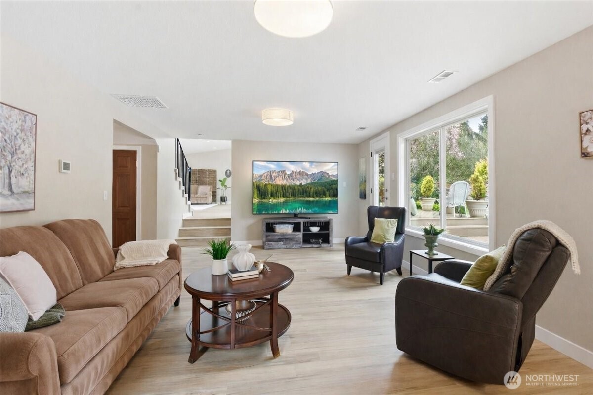 Expansive lower-level living space with patio access, oversized windows, and great flexibility for relaxing or entertaining.