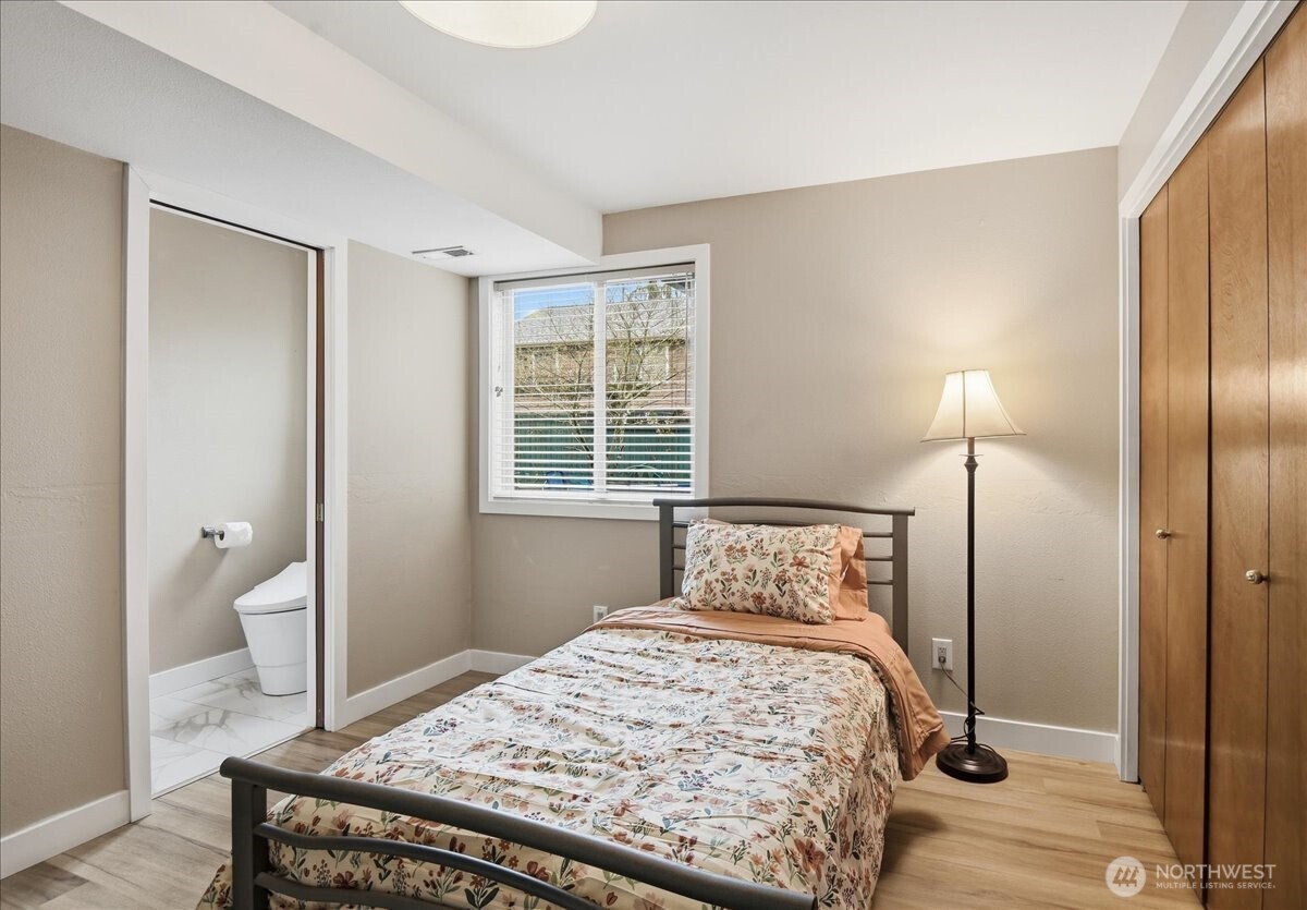 Versatile fourth bedroom with adjacent 3/4 bath, ideal for guests, office, or multi-generational living.