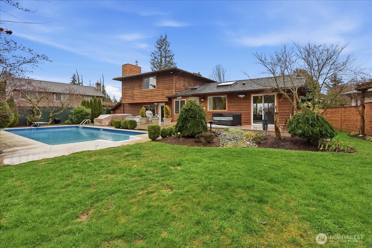 Expansive backyard with in-ground pool, hot tub, composite deck, and plenty of space to relax or entertain.
