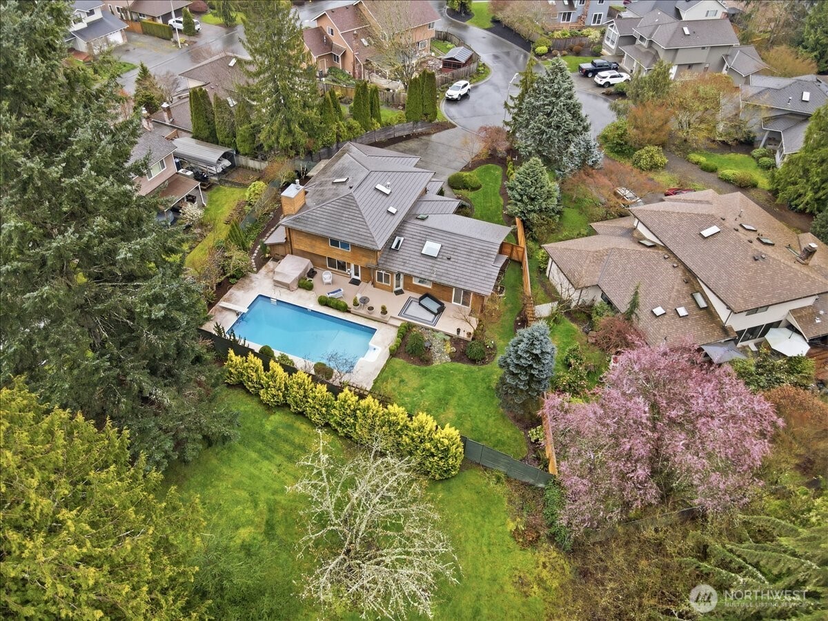 Bird’s-eye view showcasing the home’s cul-de-sac setting, spacious lot, and backyard retreat backing to the community park.