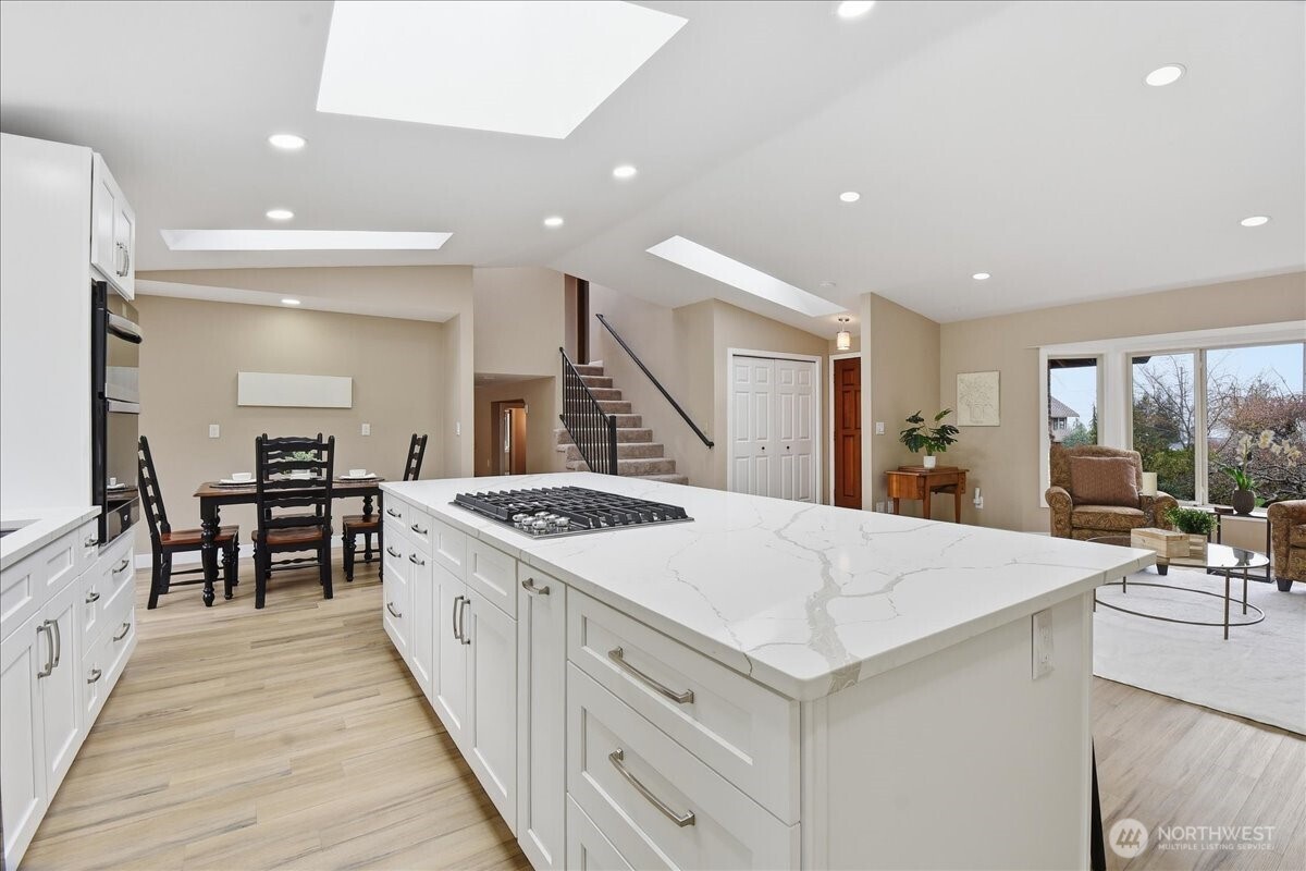 Thoughtfully remodeled kitchen with quartz surfaces, double ovens, and abundant prep and storage space.