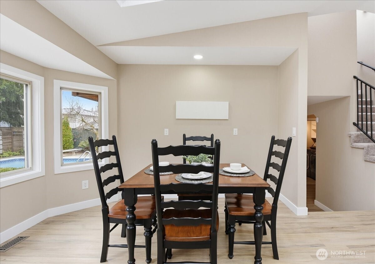 Dining area with deck access and easy connection to the kitchen, living spaces, and backyard.