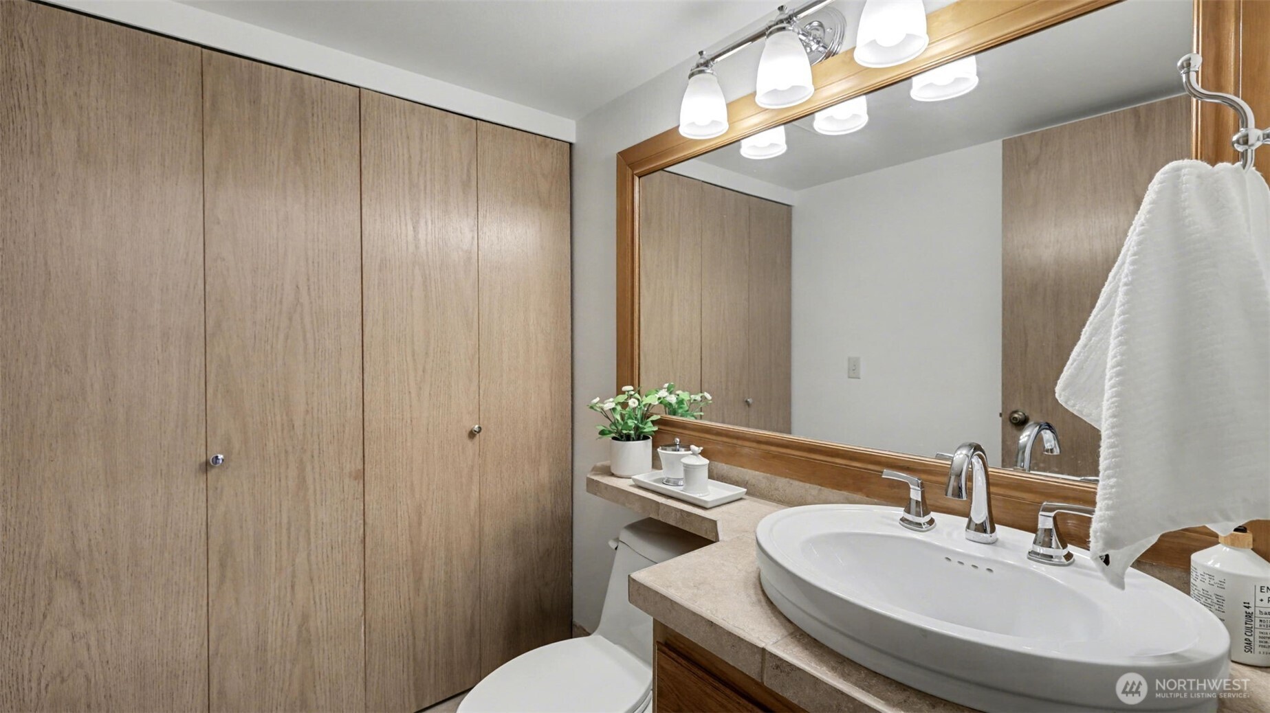 The 1st floor 1/2 bath has been combined with the laundry closet with the washer and dryer remaining.