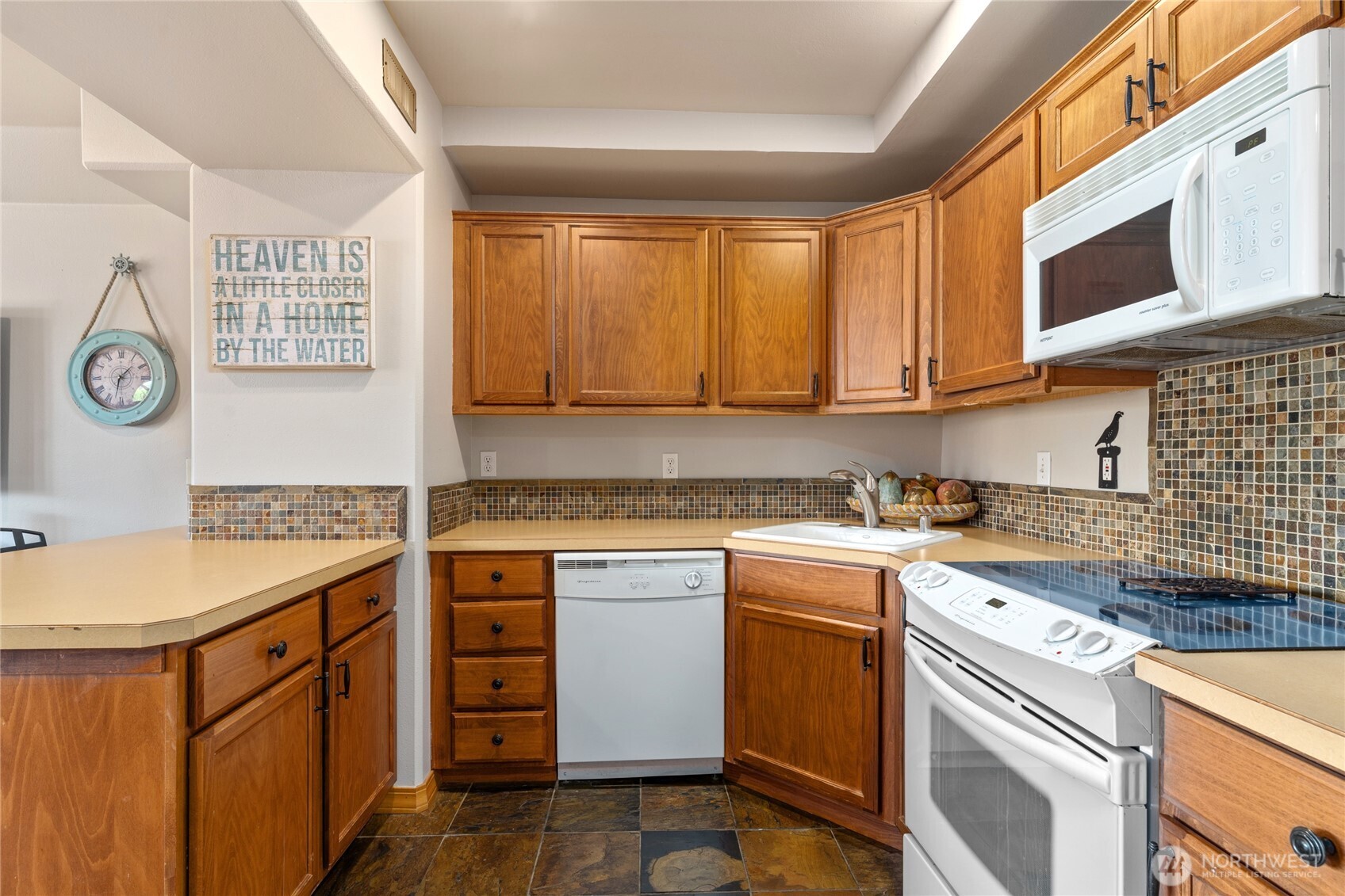 View 4 of lower level living/media room w/ fireplace, dining area and 2nd kitchen w/ doors leading out to the patio w/ pool, hot tub, basketball court and dining and lounge area.