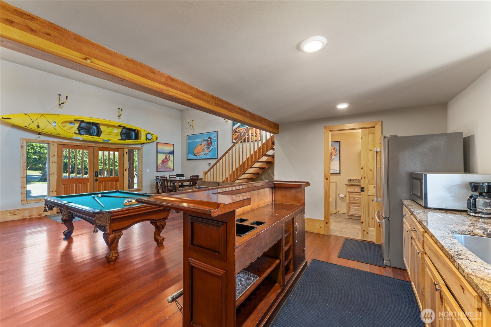 Detached carriage house w/ game area, kitchenette, bathroom plus upper balcony exercise area.