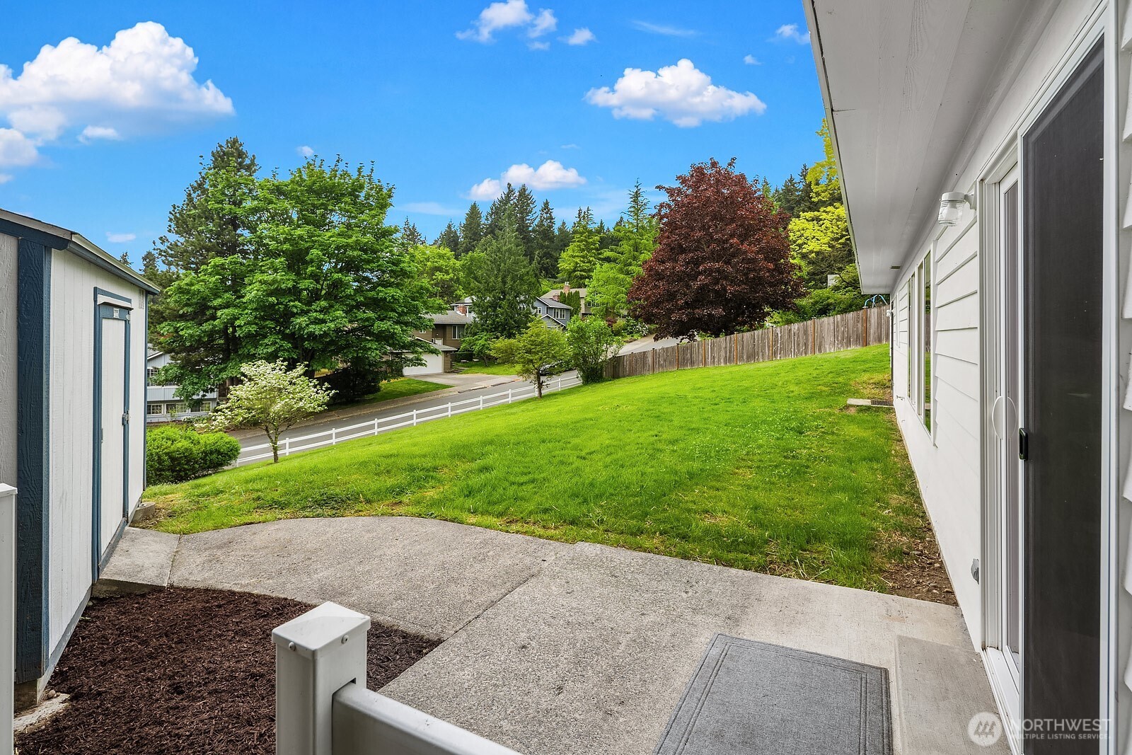 Another view of the backyard with storage shed off to the left.
