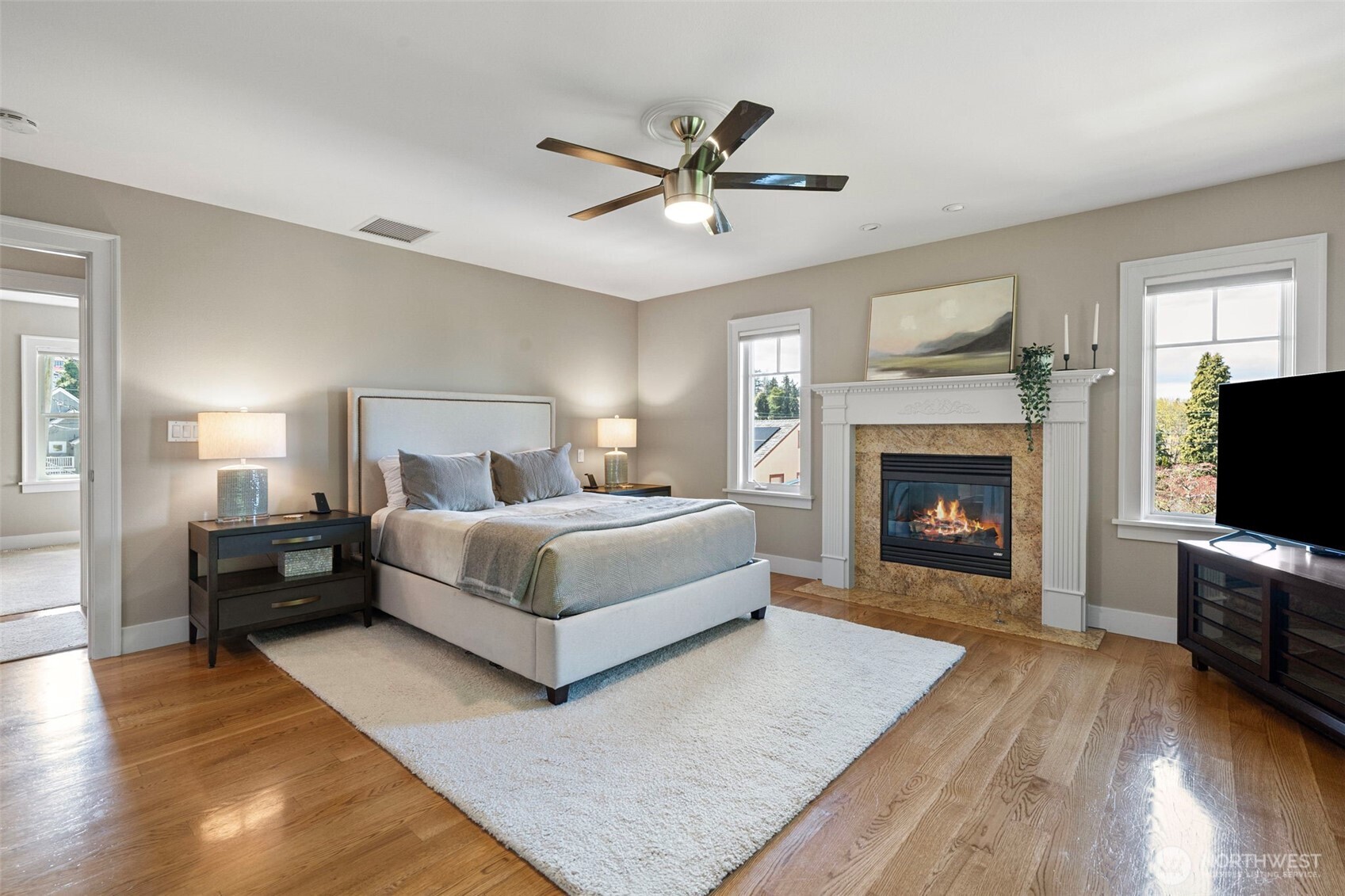 A serene primary suite featuring its own gas fireplace, a spacious walk-in closet, and a luxurious ensuite bath.