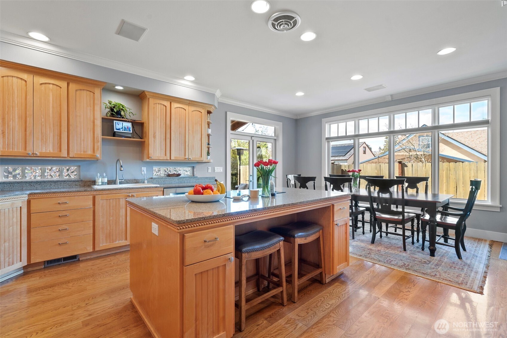 A spacious kitchen designed to seamlessly integrate the main dining area alongside inviting casual countertop seating.
