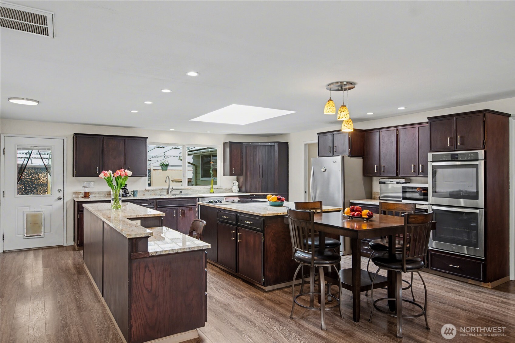 Open concept design with impressive scale and natural flow, blending kitchen and living spaces.