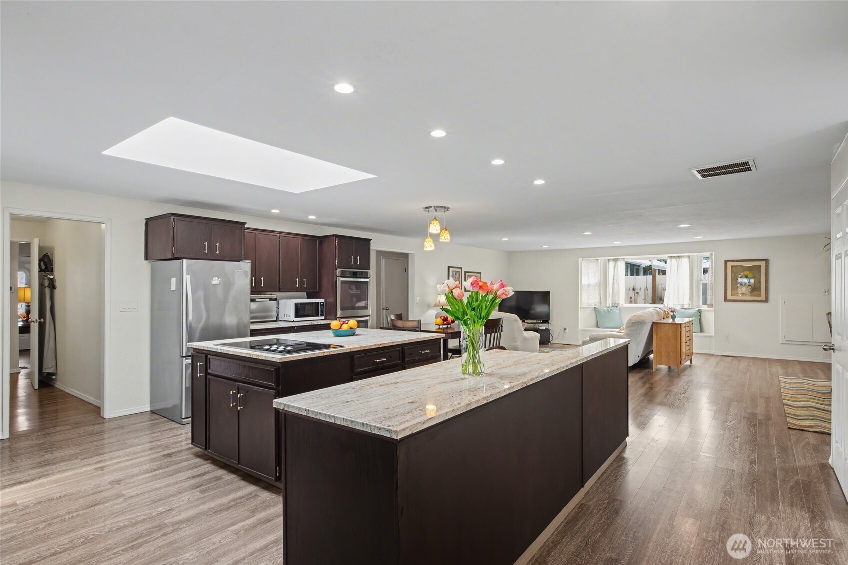 Oversized island and skylight above fille the space with natural light while enhancing functionality and warmth.