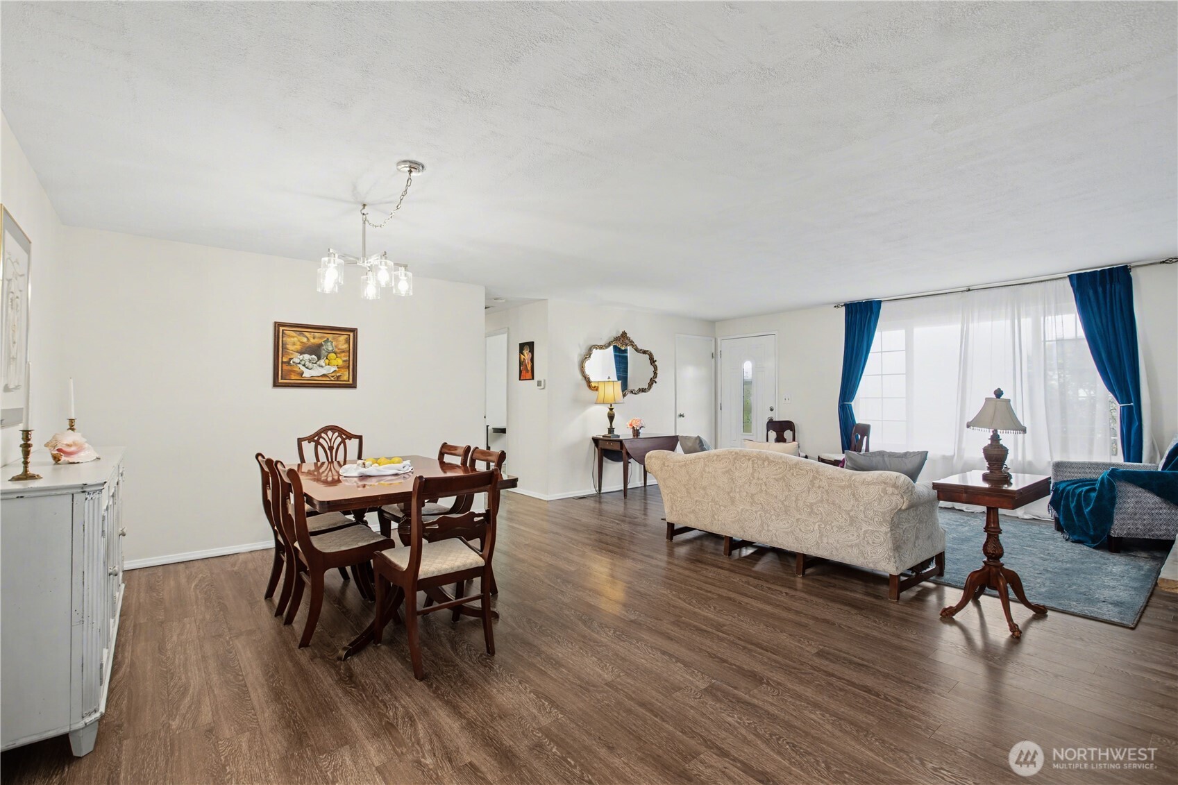 Timeless hardwood style flooring anchors this expansive living dining and living space.