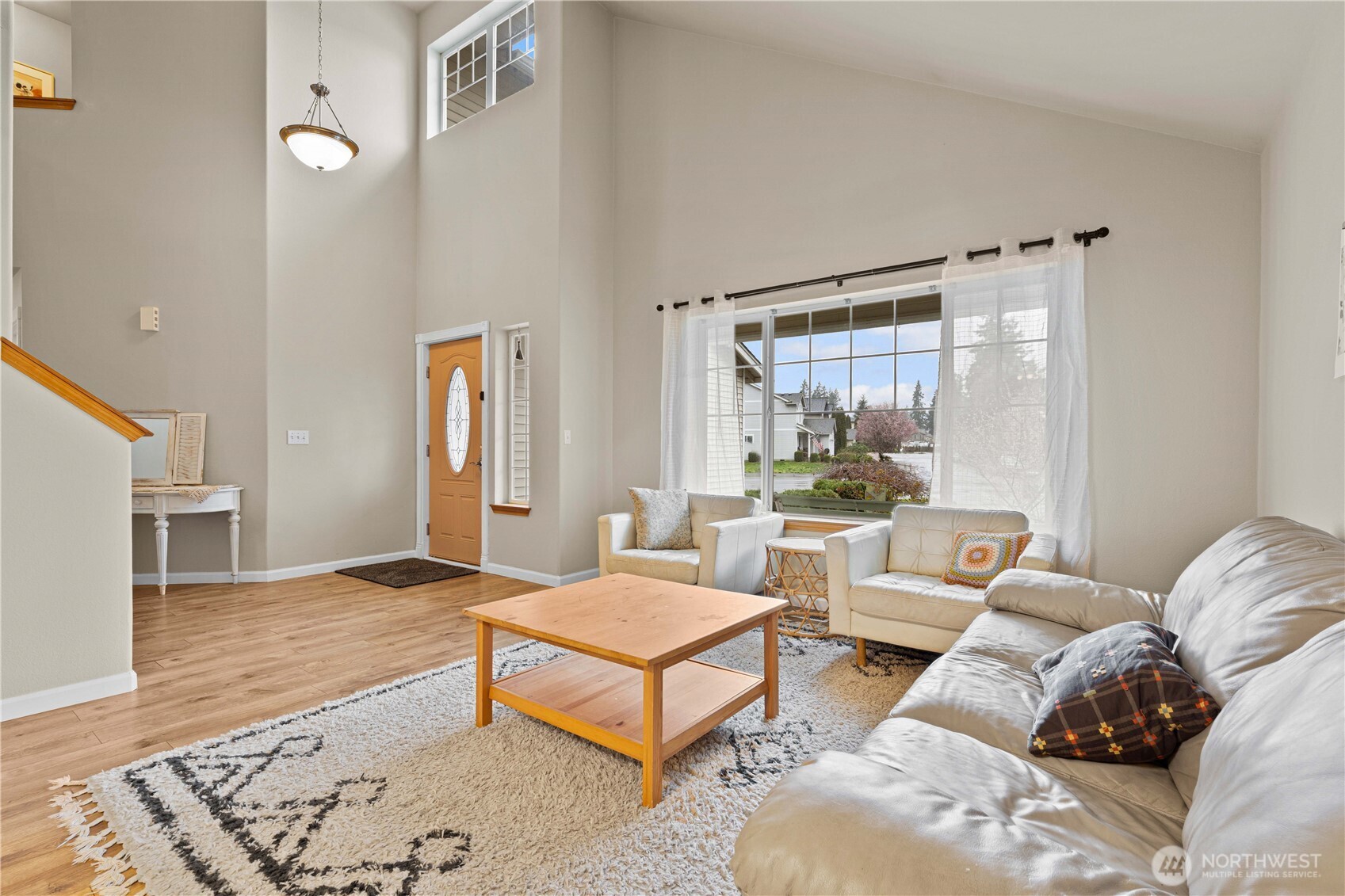Step into a light-filled living space, where a welcoming foyer and soaring vaulted ceilings create an open, airy first impression.