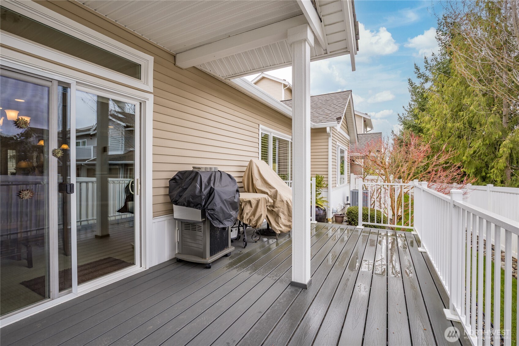 Outdoor living at its best! The partially covered back deck was fully refreshed in 2024, offering a serene year-round space