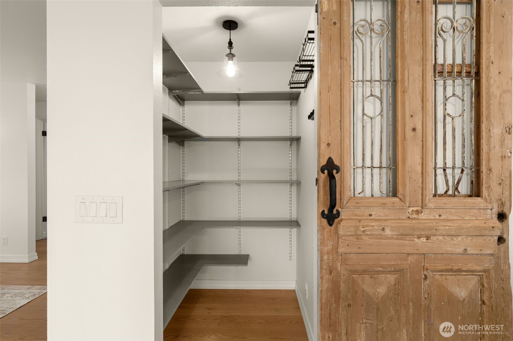 Walk-in pantry with sliding barn door.