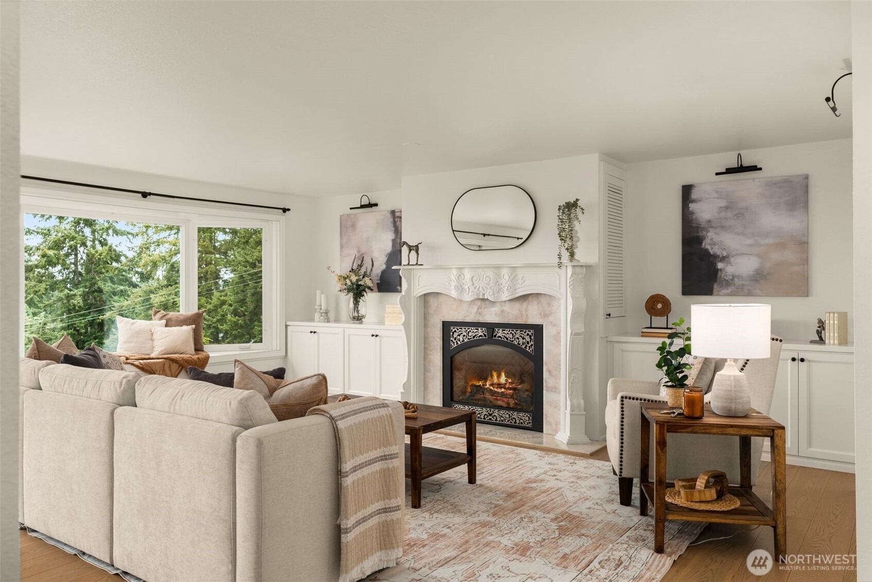 Formal living room w/natural gas fireplace, custom mantel, framed by built in cabinetry & shelving.