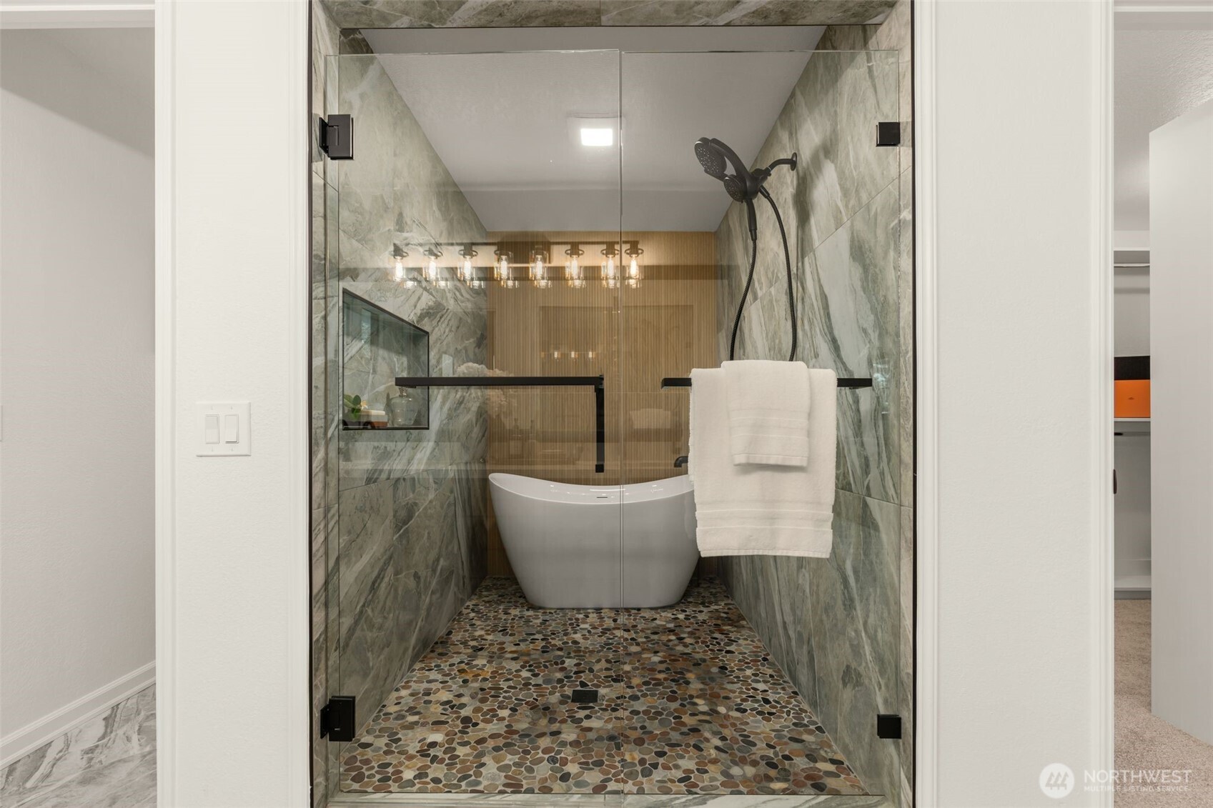 Spa-inspired primary bath en suite with free-standing tub perfectly nestled within the shower surround, magazine worthy.