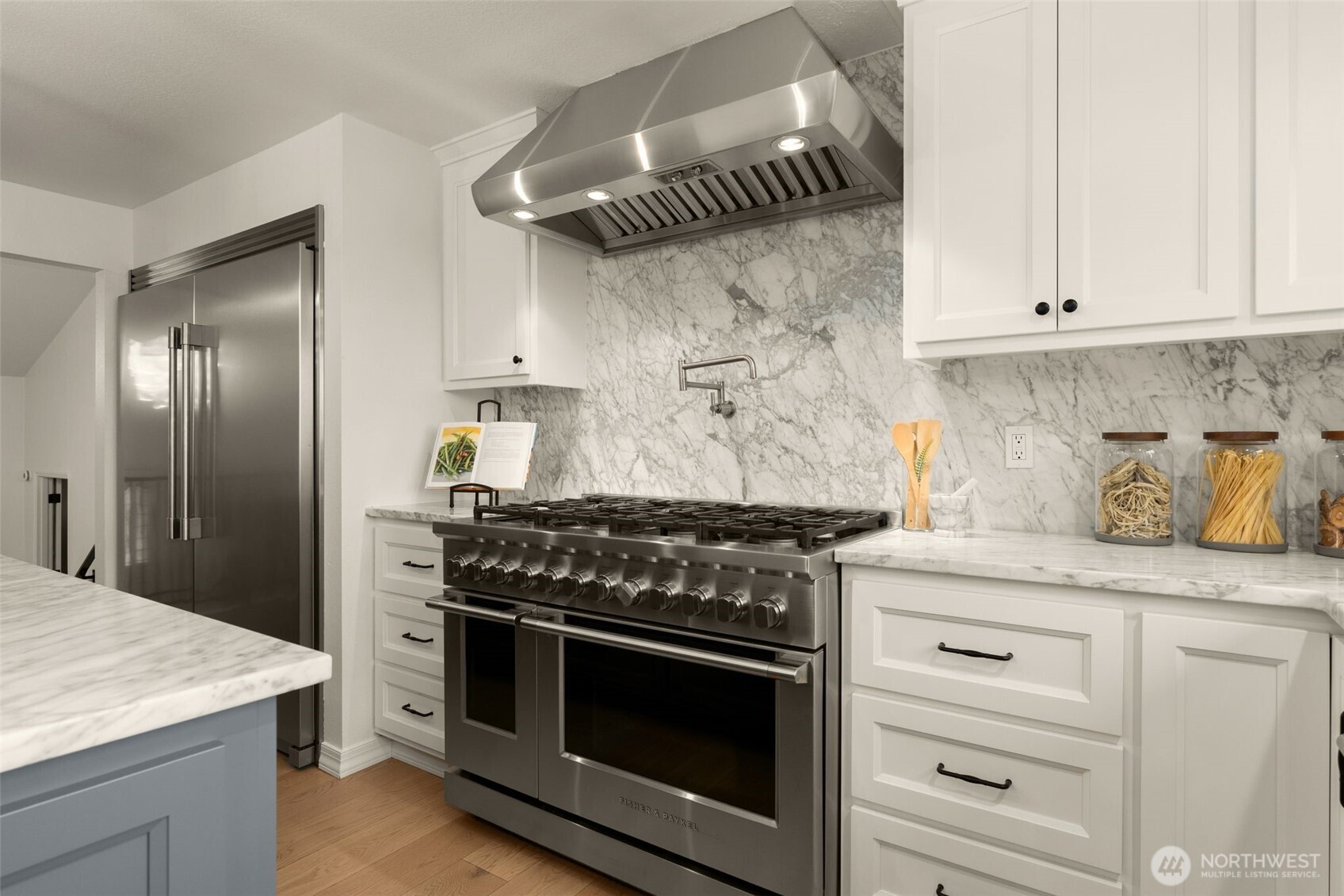 Full size freezer & refrigerator, 12 natural gas burners in all with island cooktop, pot filler, Fisher & Paykel double oven.