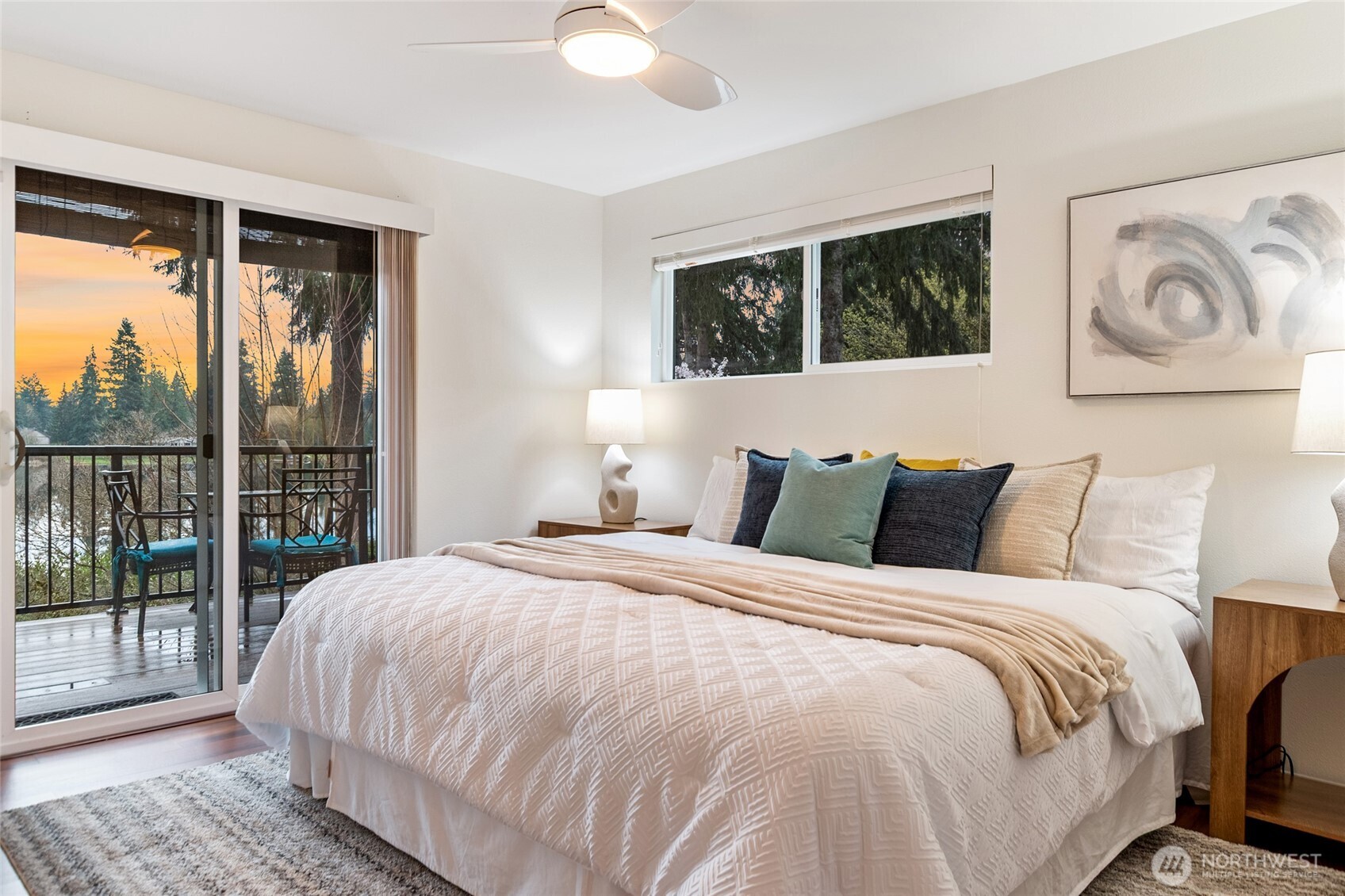 Primary bedroom with private deck access and tranquil Echo Lake waterfront views