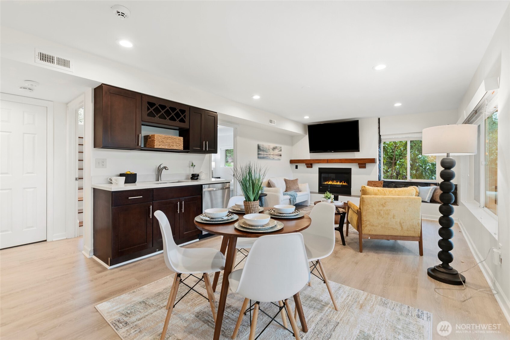 Spacious lower level with kitchenette, living area, and fireplace ideal for guests or multi-generational living