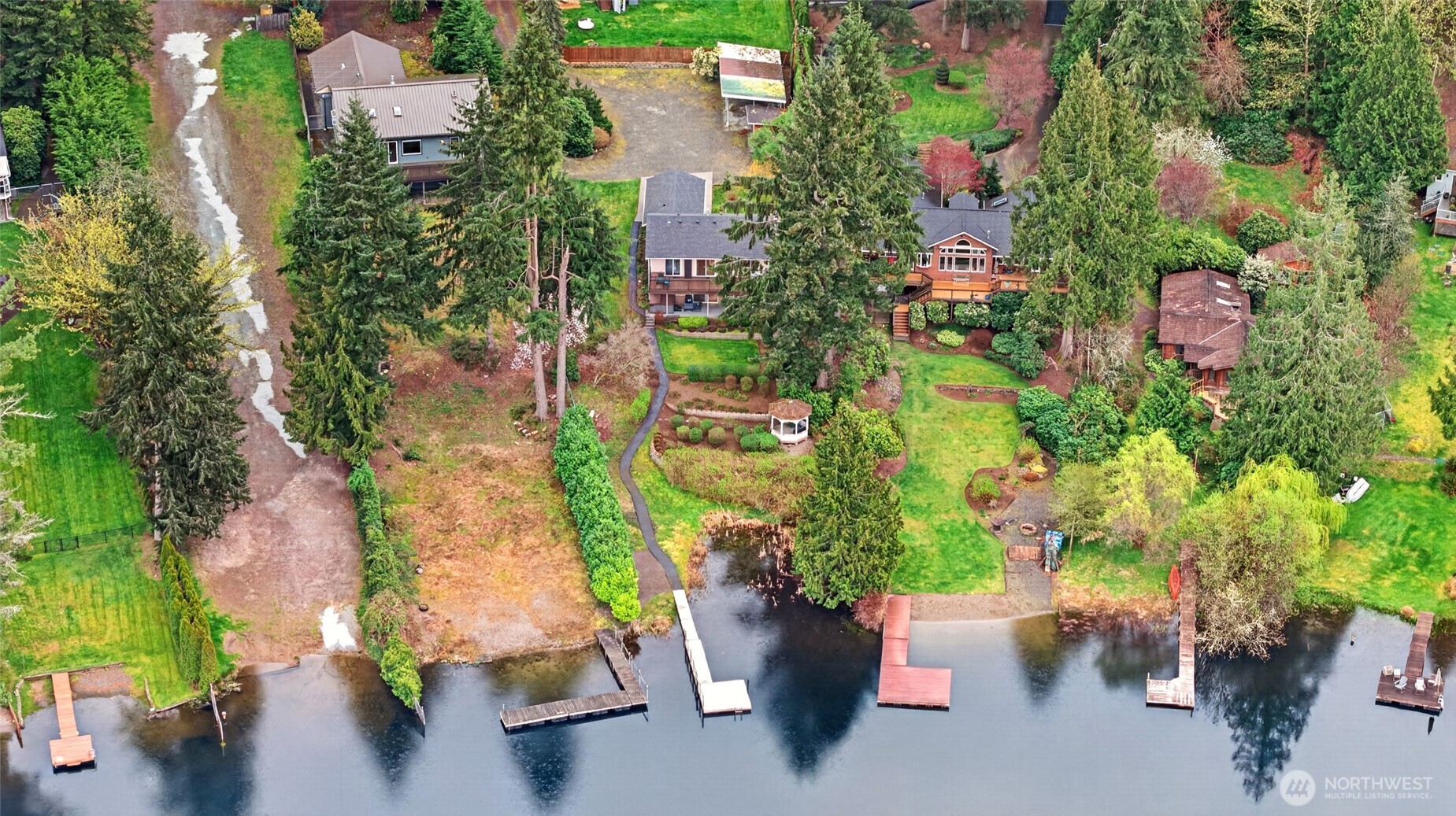 Aerial view of Echo Lake waterfront property showcasing private setting, mature landscaping, and direct water access