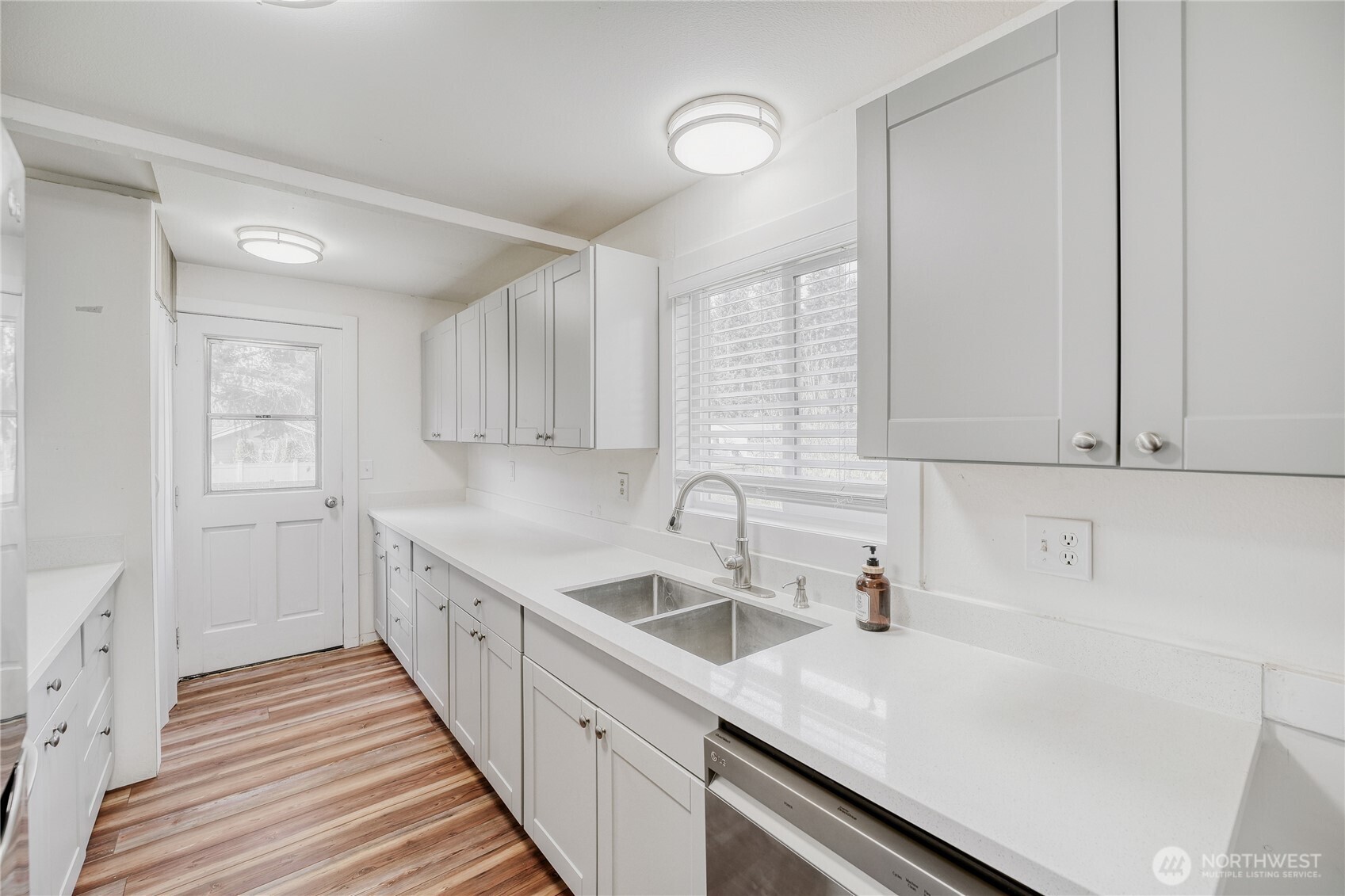Sleek quartz counters and stainless steel appliances highlight this functional, open-concept kitchen — the heart of the home in desirable Union Hill, Redmond.
