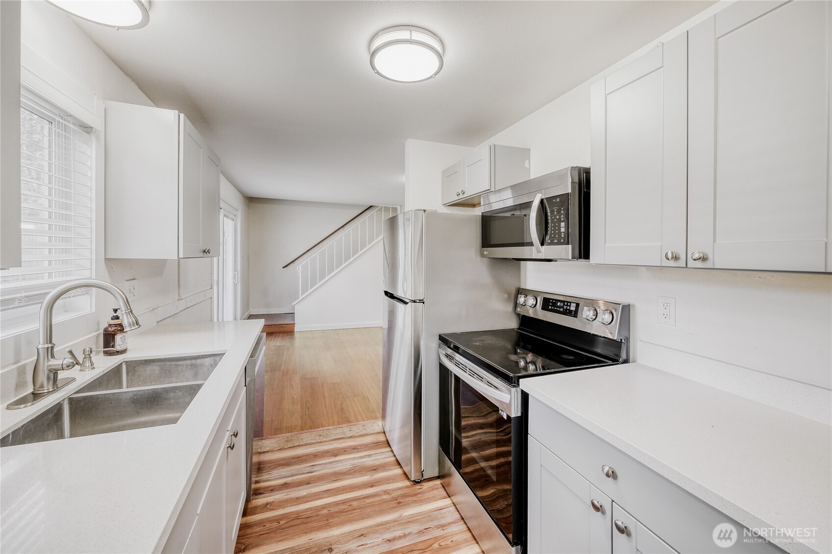 Modern kitchen workspace with elegant quartz counters and stainless steel appliances. A standout feature in this beautifully updated 1,690 sq ft residence with top-rated schools just minutes away in Union Hill.