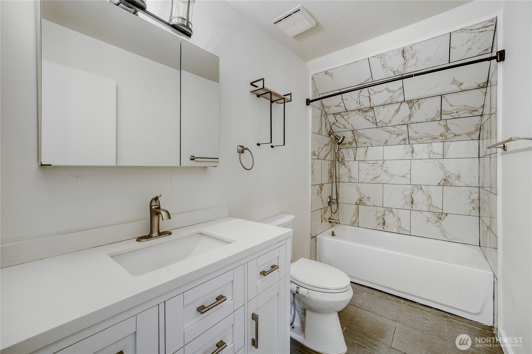 Modern full bathroom featuring quartz counters and a fresh tile surround shower in this updated Union Hill home