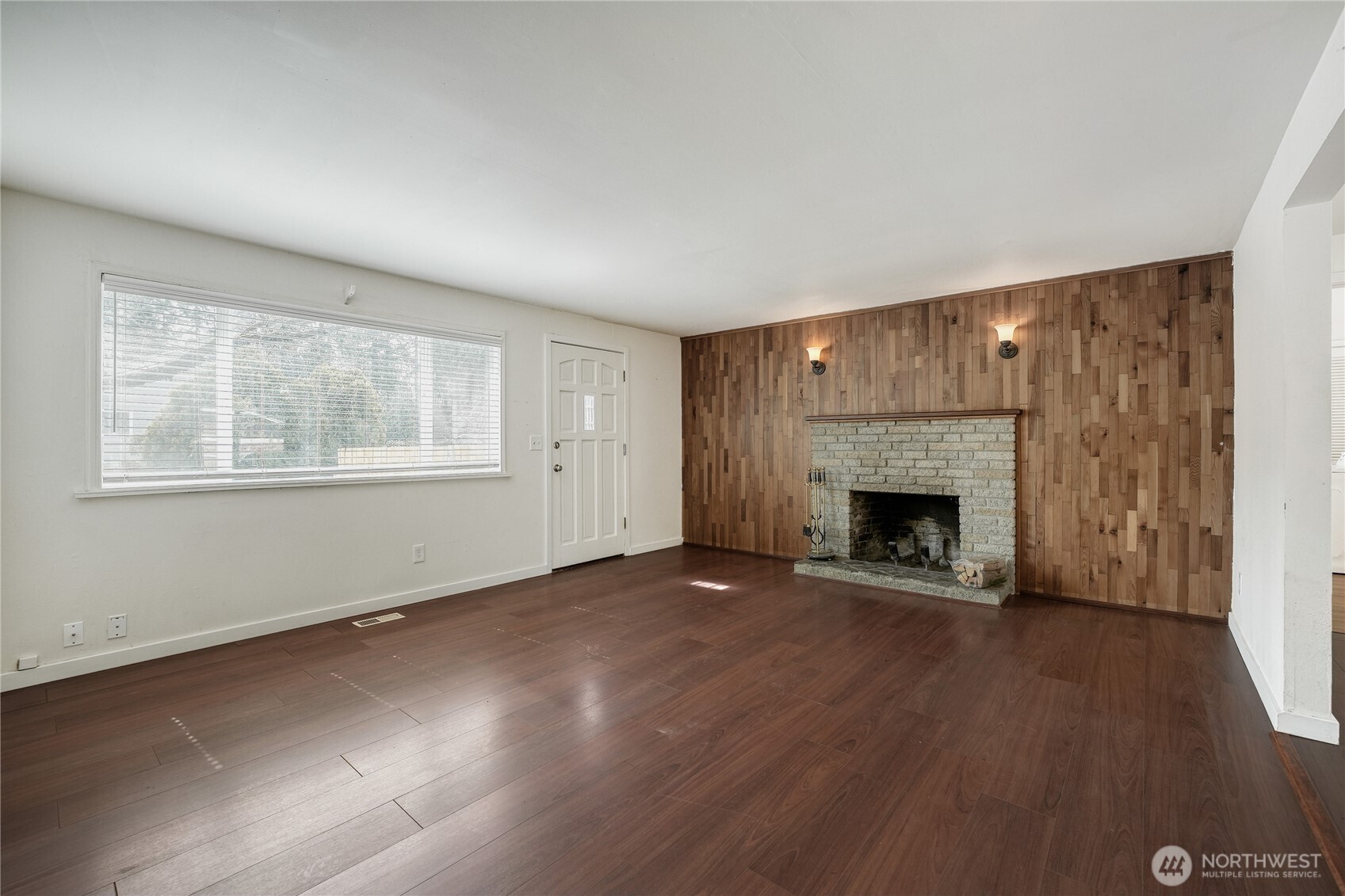Beautifully updated living room featuring easy-care LVP flooring and a striking wood-burning fireplace. Open-concept layout ideal for family gatherings in this Redmond home located in the highly sought-after Union Hill neighborhood.