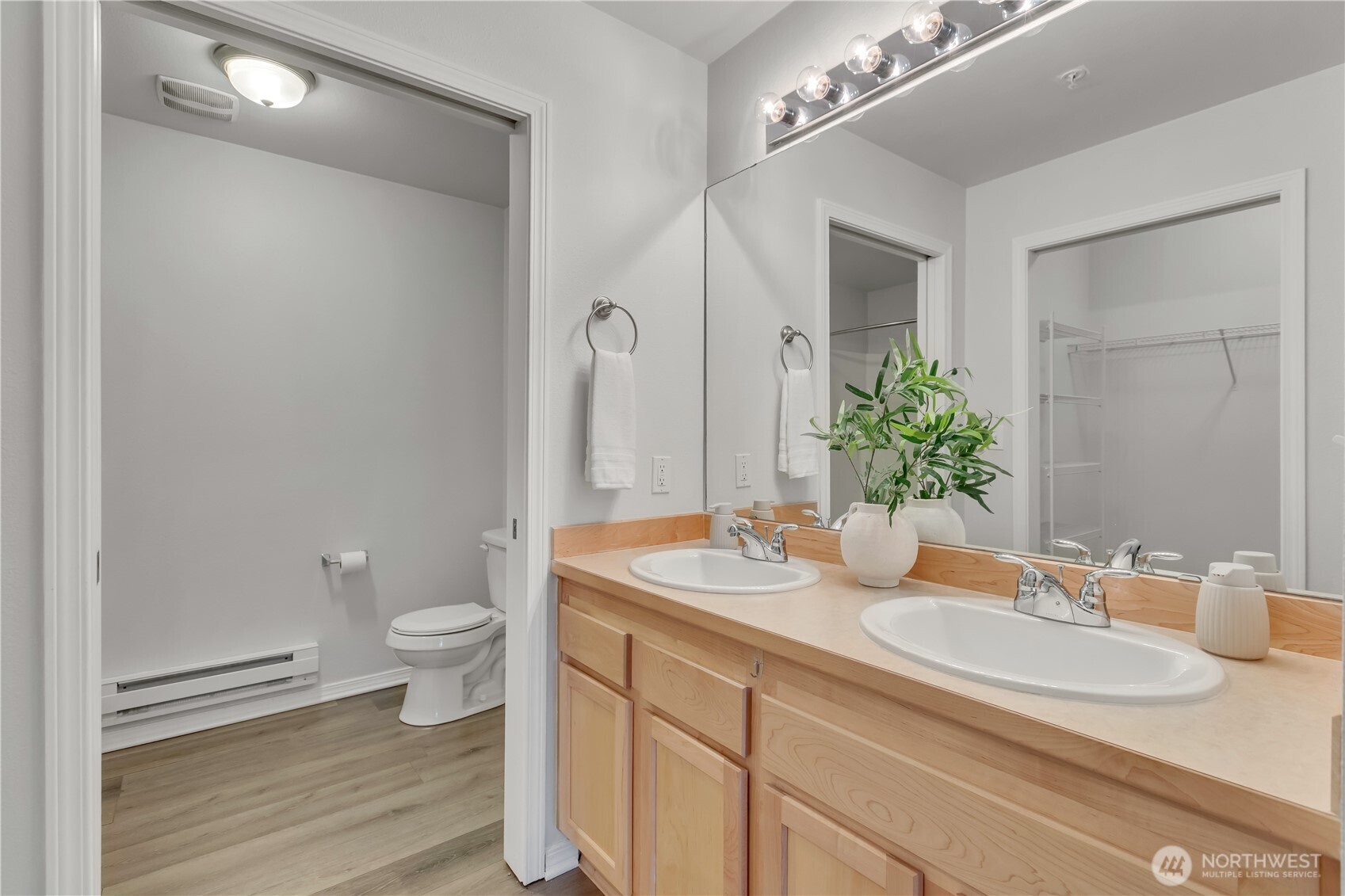 Double Vanity with plenty of storage is accessed just off the primary suite.