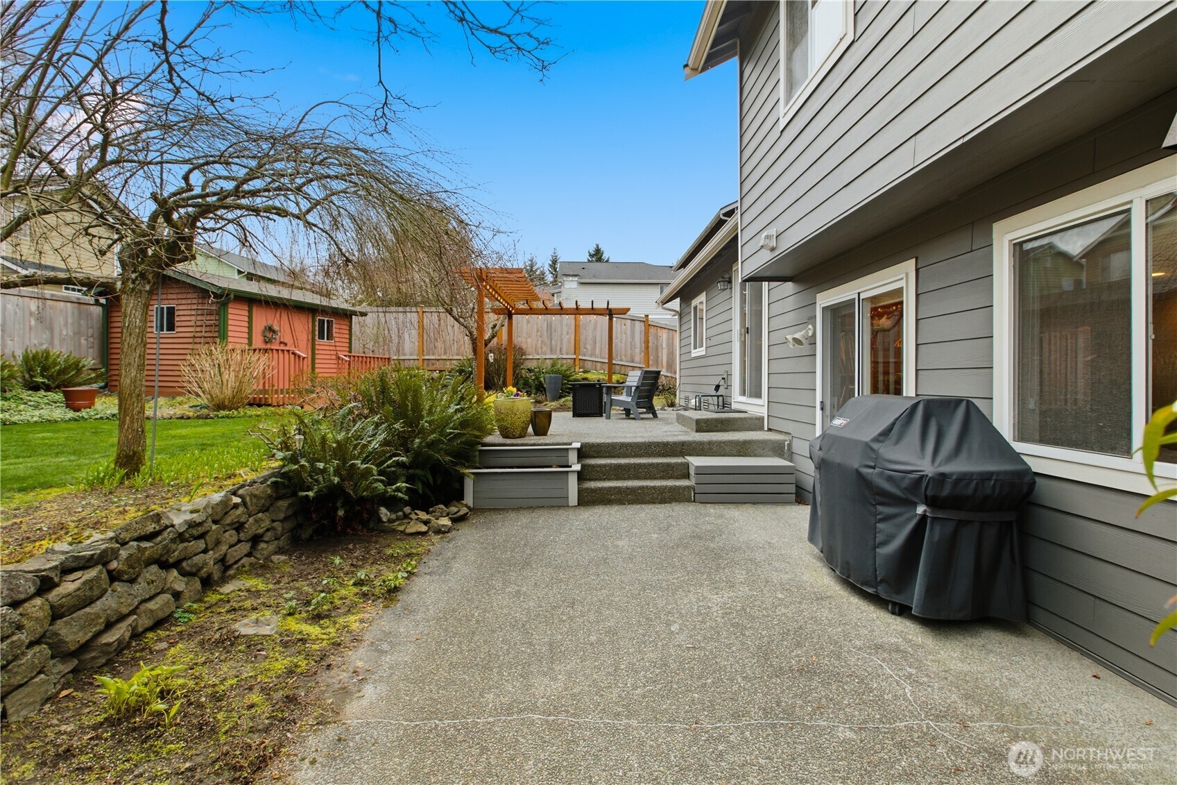 Two tiered outdoor patio provides room for entertaining and cooking.