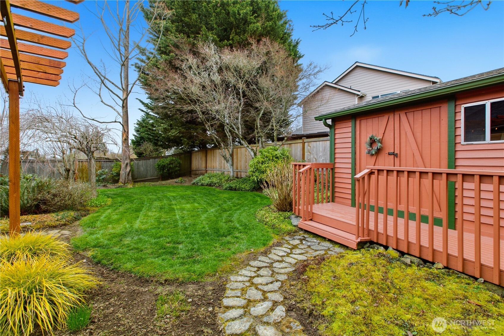 Stone walkway leads to the large outdoor garden shed.