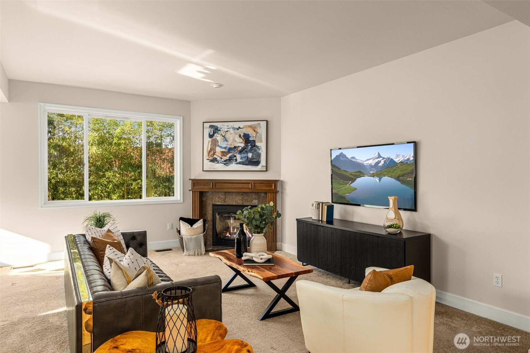 Cozy living room with gas fireplace overlooks the outdoor oasis.