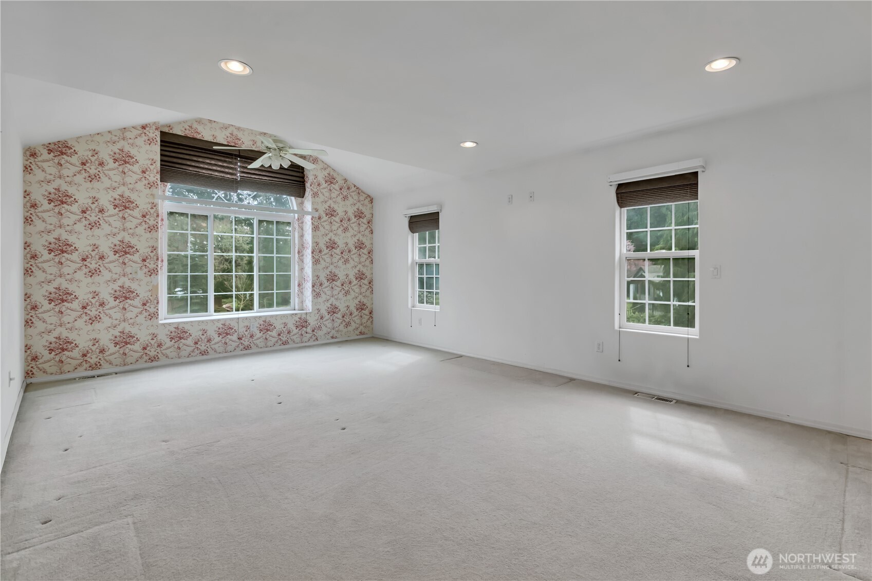Large primary bedroom with lots of natural light