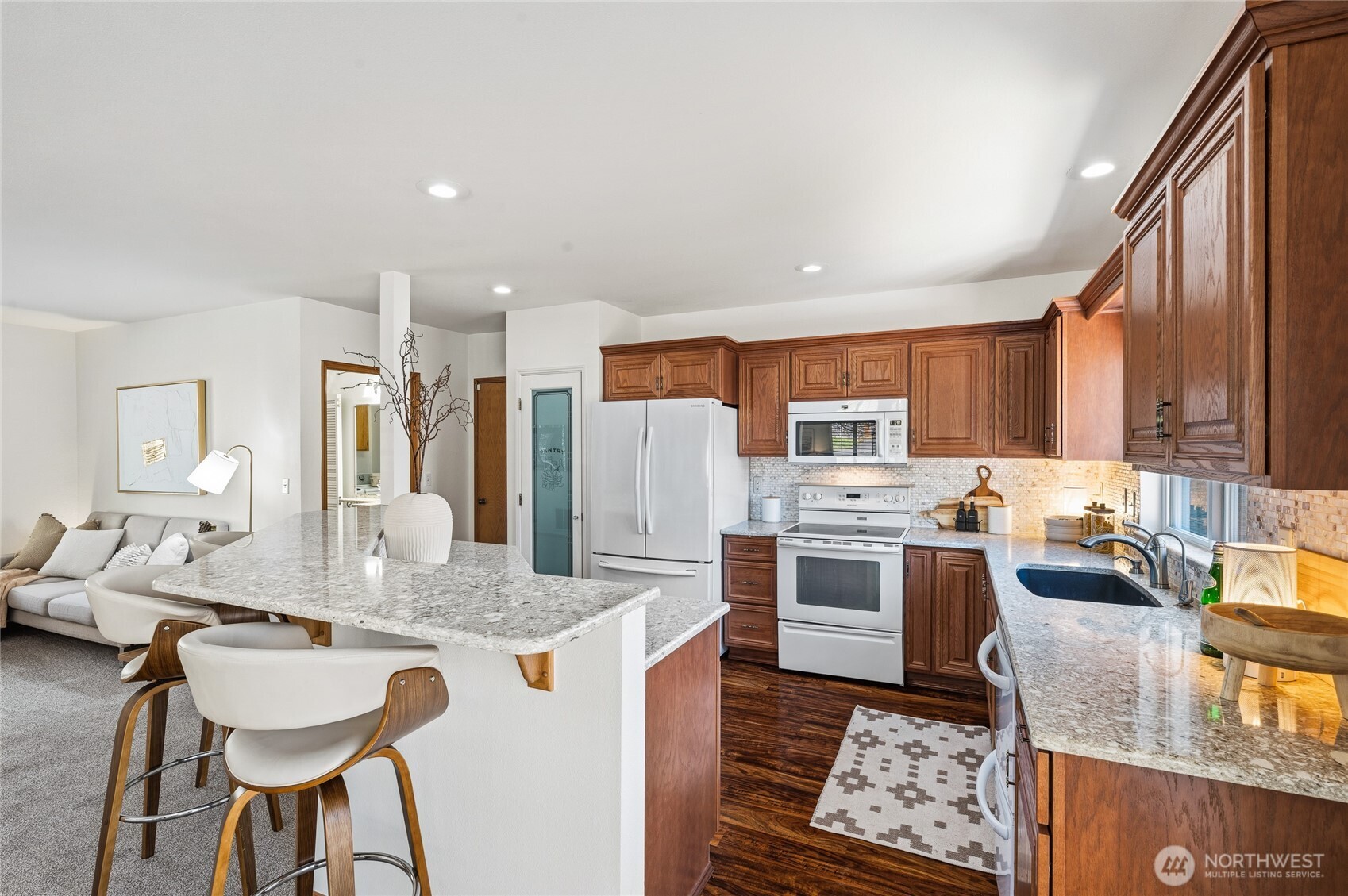 Granite slab counters, full-height tile backsplash, even a double dishwasher!