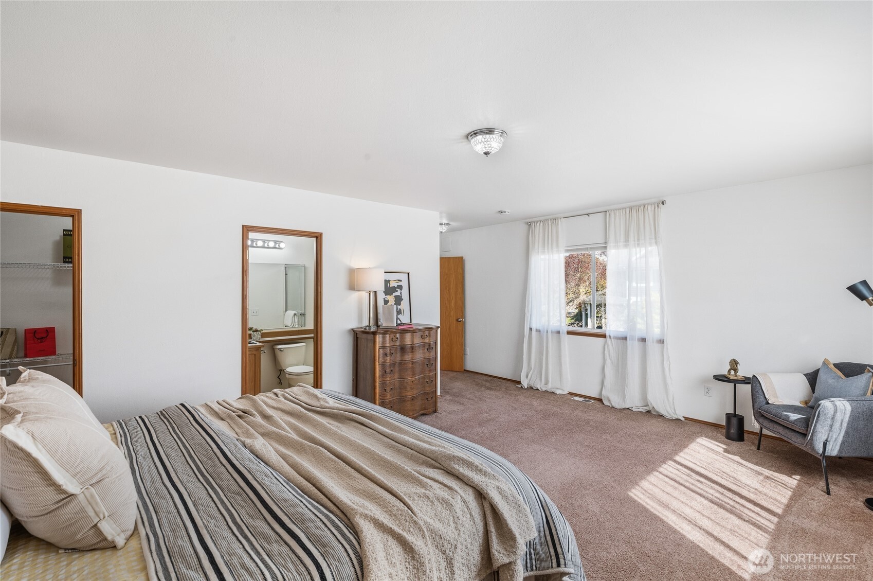 Primary suite (one of two!) includes private bath & walk in closet.