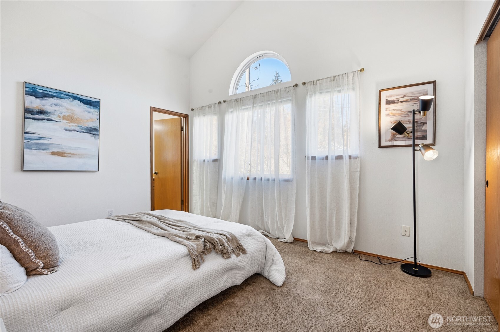 Second primary suite on the upper level has cathedral ceilings and a private en-suite.