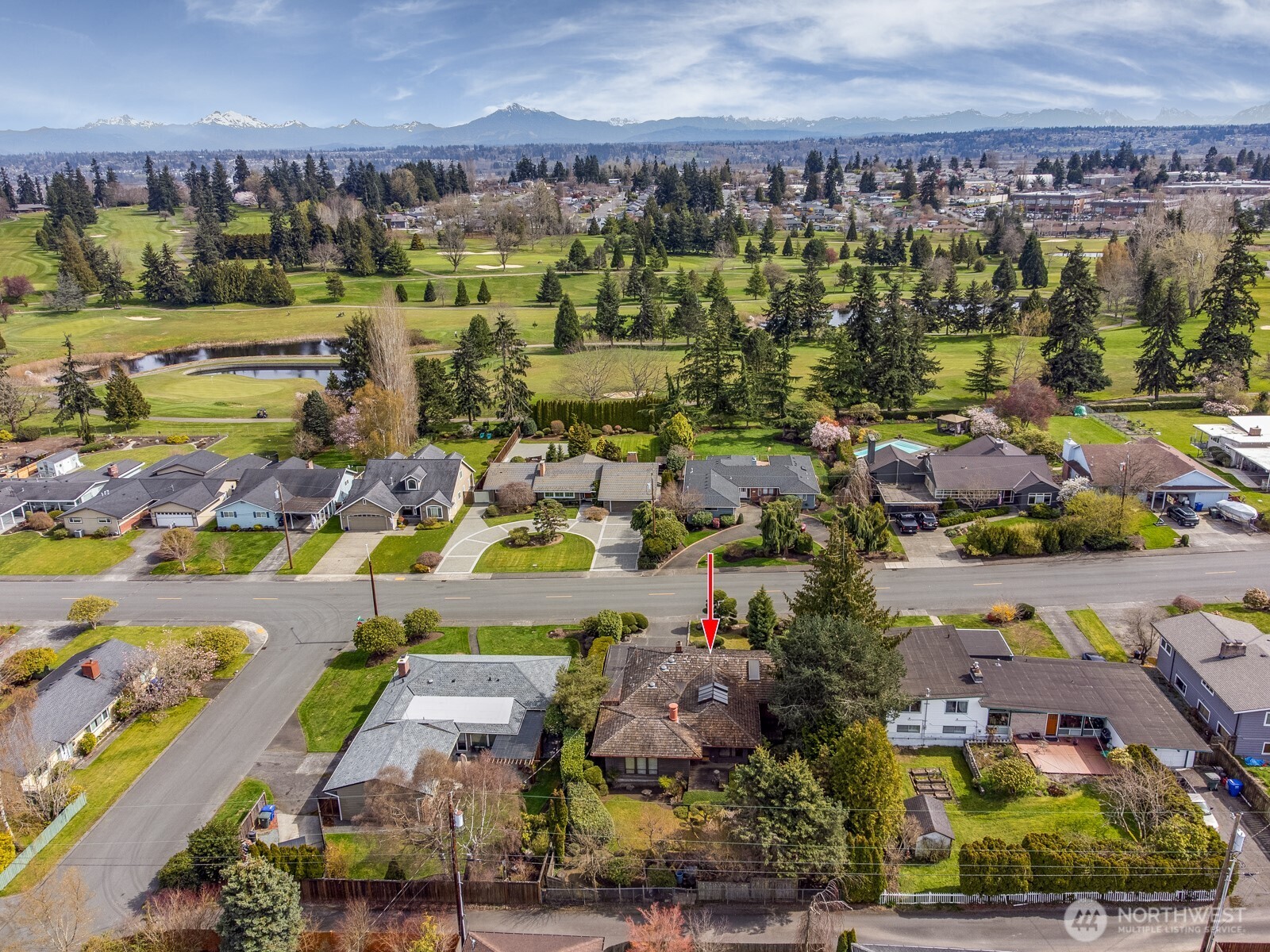 Drone photo to the east over golf course and toward the Cascade Mountain Range.