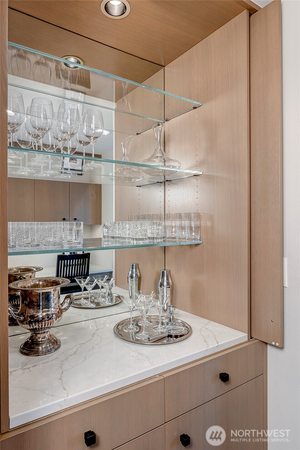Thoughtfully designed for gatherings, the space features a built in bar, pearl ice machine, and beverage refrigerator, making hosting feel easy and elevated.