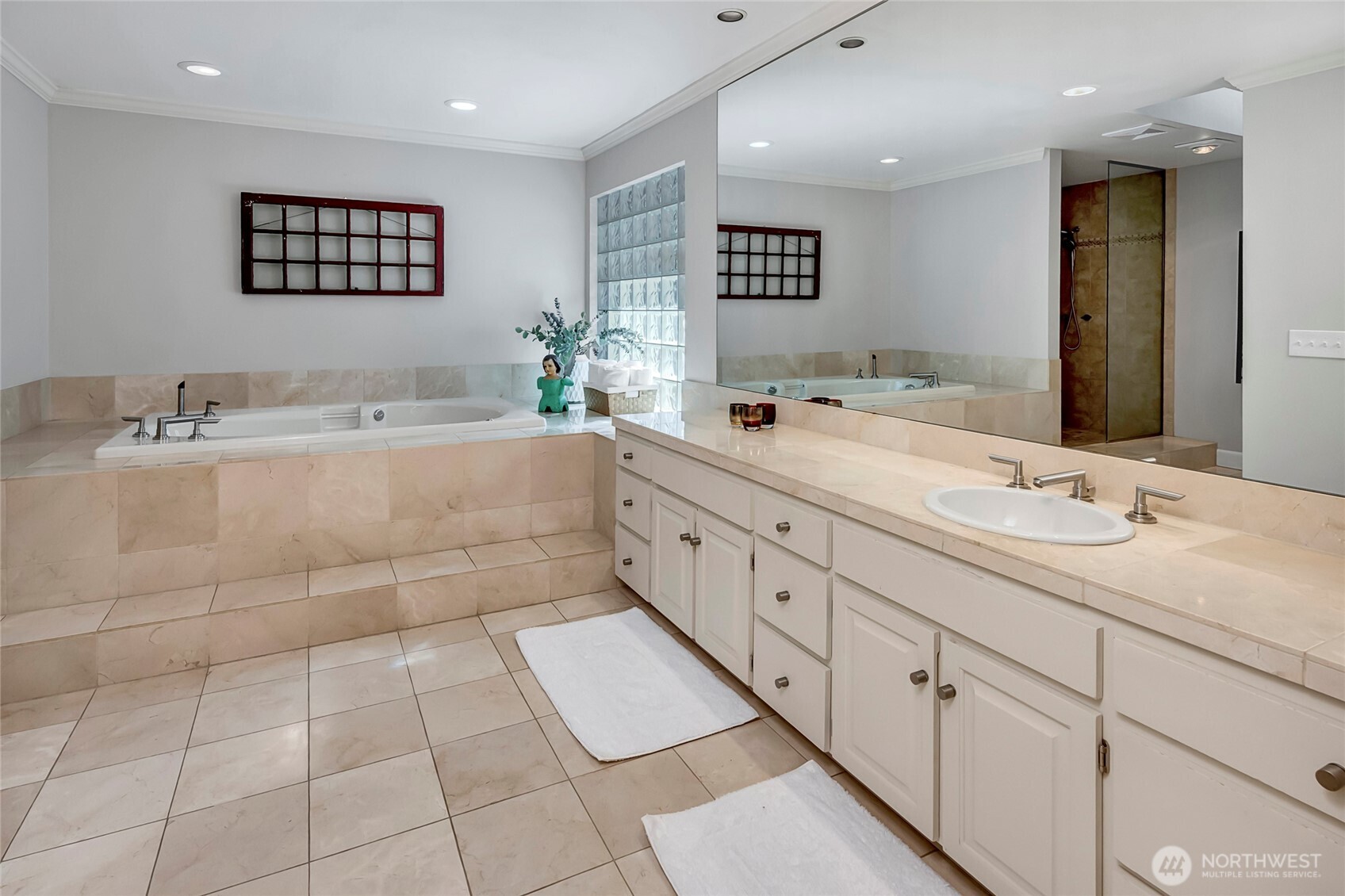 The ensuite bath is equally spacious, featuring a soaking tub, dual sinks, a separate shower, and a towel warmer, creating a spa like experience.